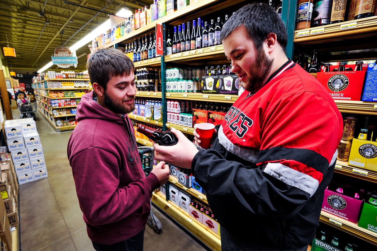 Brett Menser, left, and Alex Reindel drove from Tipp City to shop the large beer selection at Jungle Jim’s International Market in Fairfield for New Year’s Eve supplies. NICK GRAHAM/STAFF