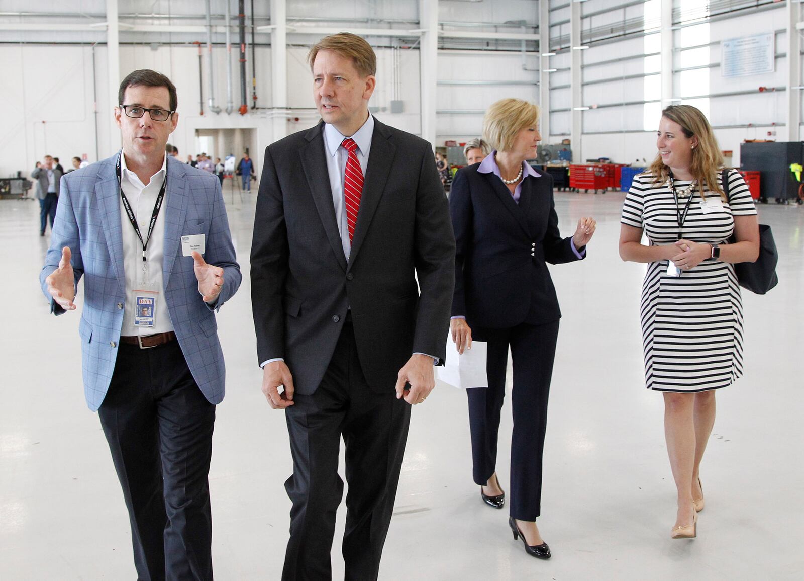 Candidate for Ohio Governor Richard Crodray, center, talks with PSA Airlines president Dion Flannery, left, as he arrives with running mate Betty Sutton at a Dayton Chamber of Commerce meeting on Thursday, August 16.   TY GREENLEES / STAFF