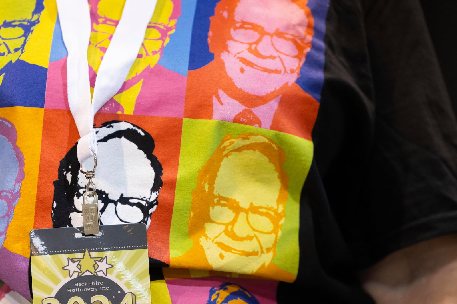 FILE - Shareholder Tina Schmidt of Cozad, Neb., wears a shirt with Warren Buffett's portrait in the style of an Andy Warhol painting at the Berkshire Hathaway annual meeting on May 4, 2024, in Omaha, Neb. (AP Photo/Rebecca S. Gratz, File)