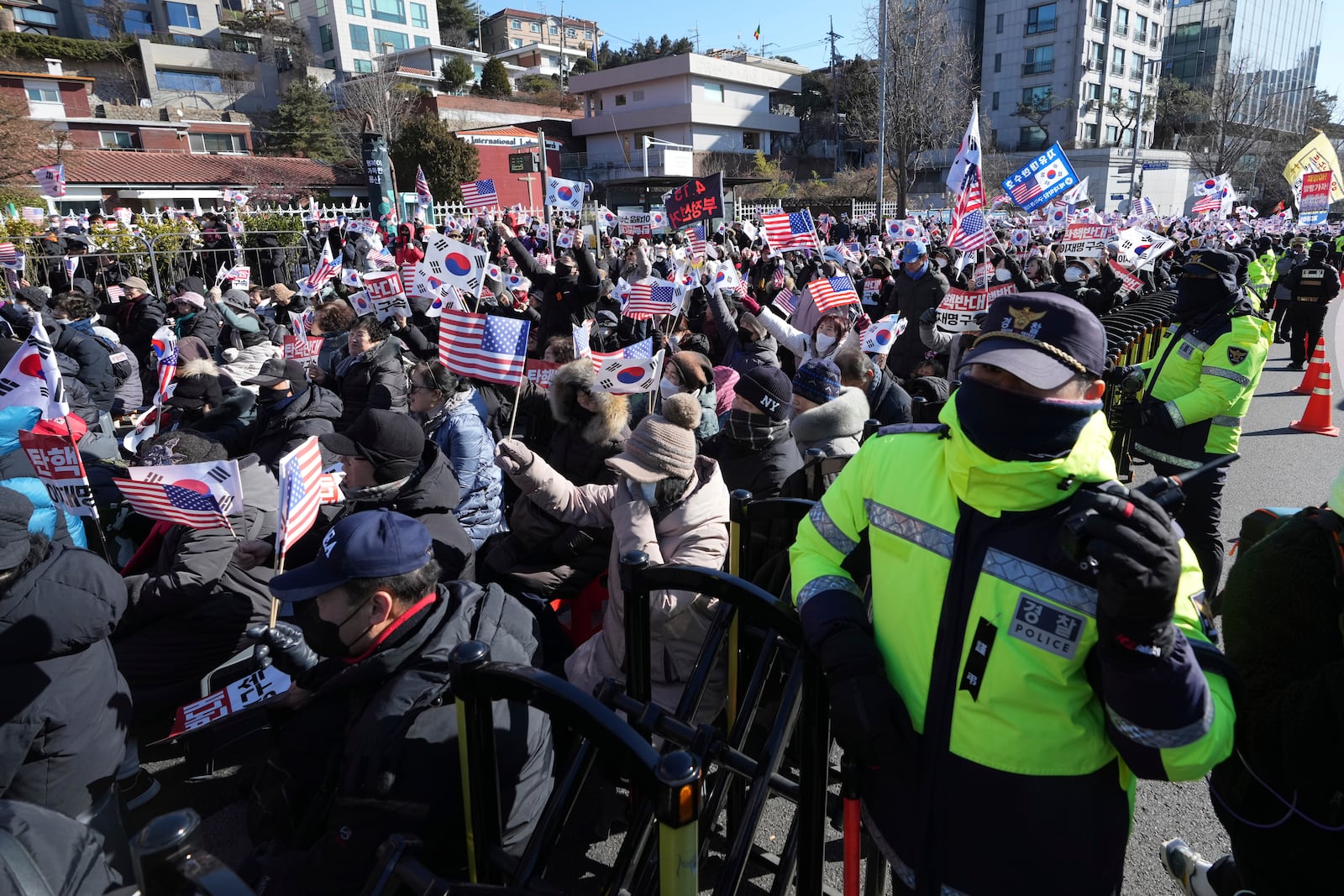 Supporters of impeached South Korean President Yoon Suk Yeol stage a rally after hearing a news that a court issued warrants to detain Yoon, near the presidential residence in Seoul, South Korea, Tuesday, Dec. 31, 2024. (AP Photo/Lee Jin-man)