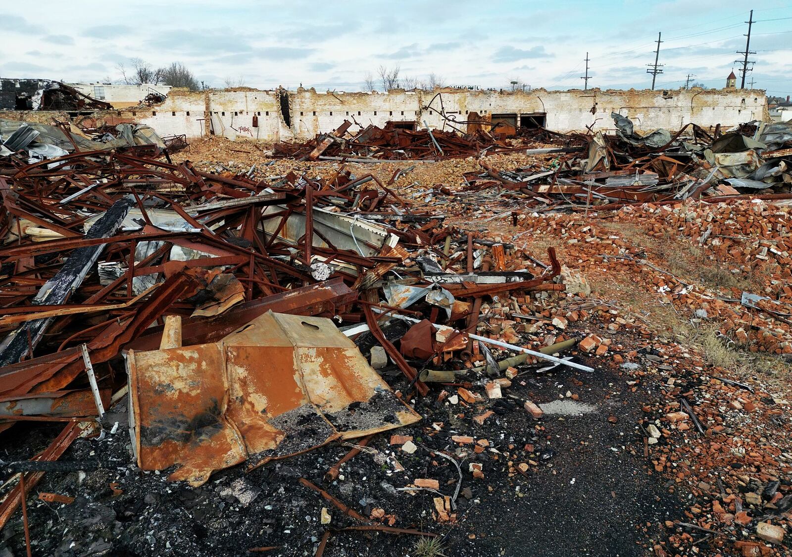 Debris remains nearly four years after the former Middletown Paperboard complex was destroyed by fire. Firefighters from multiple departments battled the fire that started on Jan. 1, 2020. NICK GRAHAM / STAFF