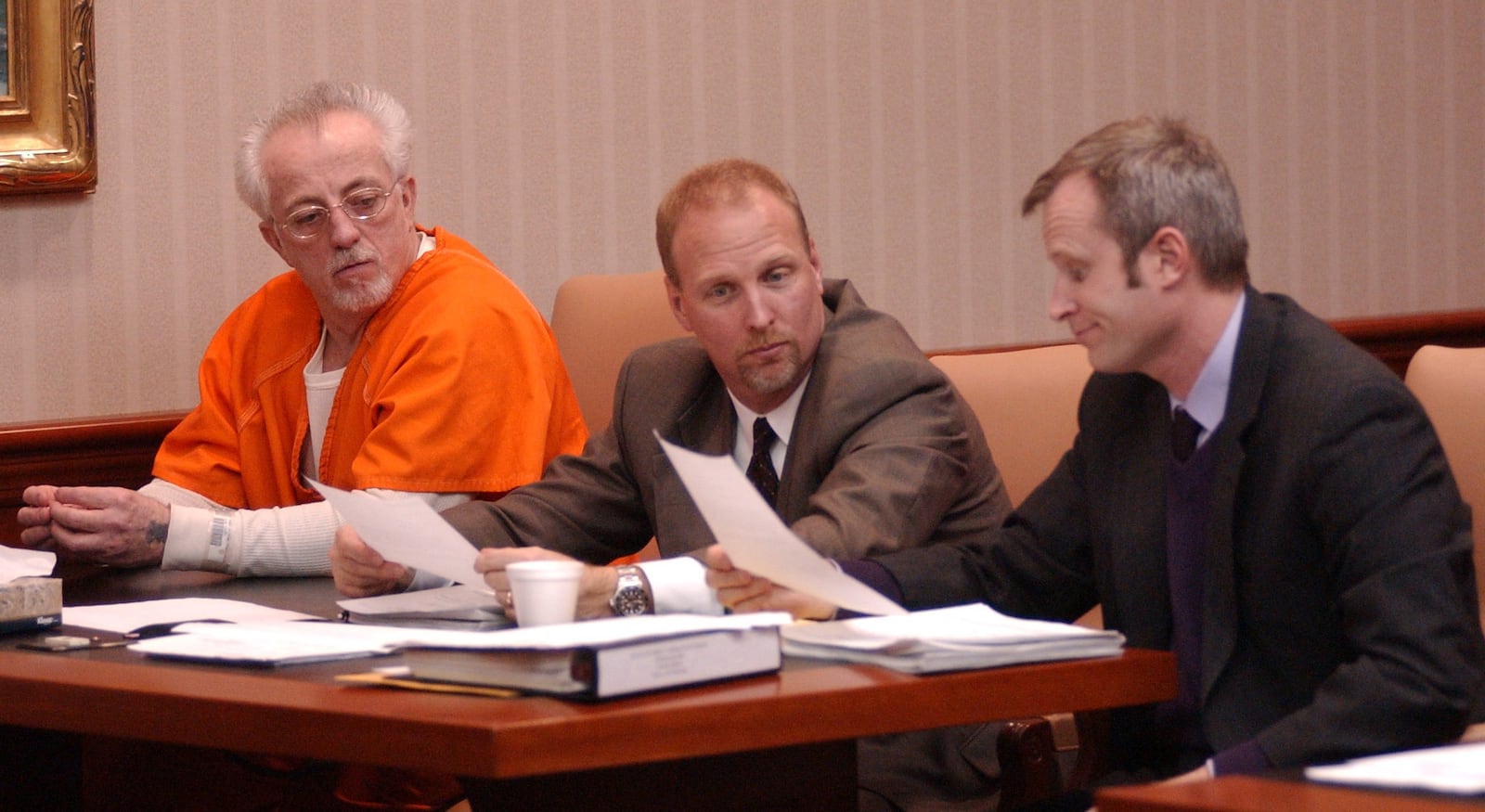 Aggravated murder defendant Donald Ketterer (left) sits next to attorneys Greg Howard (center) and Chris Pagan during a motion hearing in Judge Patricia Oney's courtroom on Jan. 1, 2004. STAFF