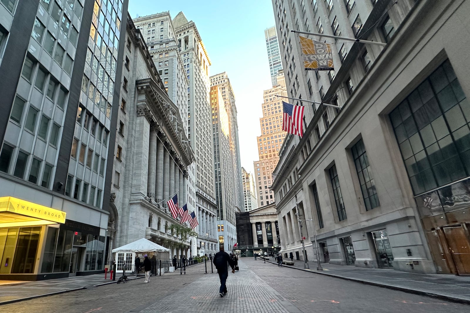 FILE - American flags, left, hang from the New York Stock Exchange on Oct. 16, 2024, in New York. (AP Photo/Peter Morgan, File)