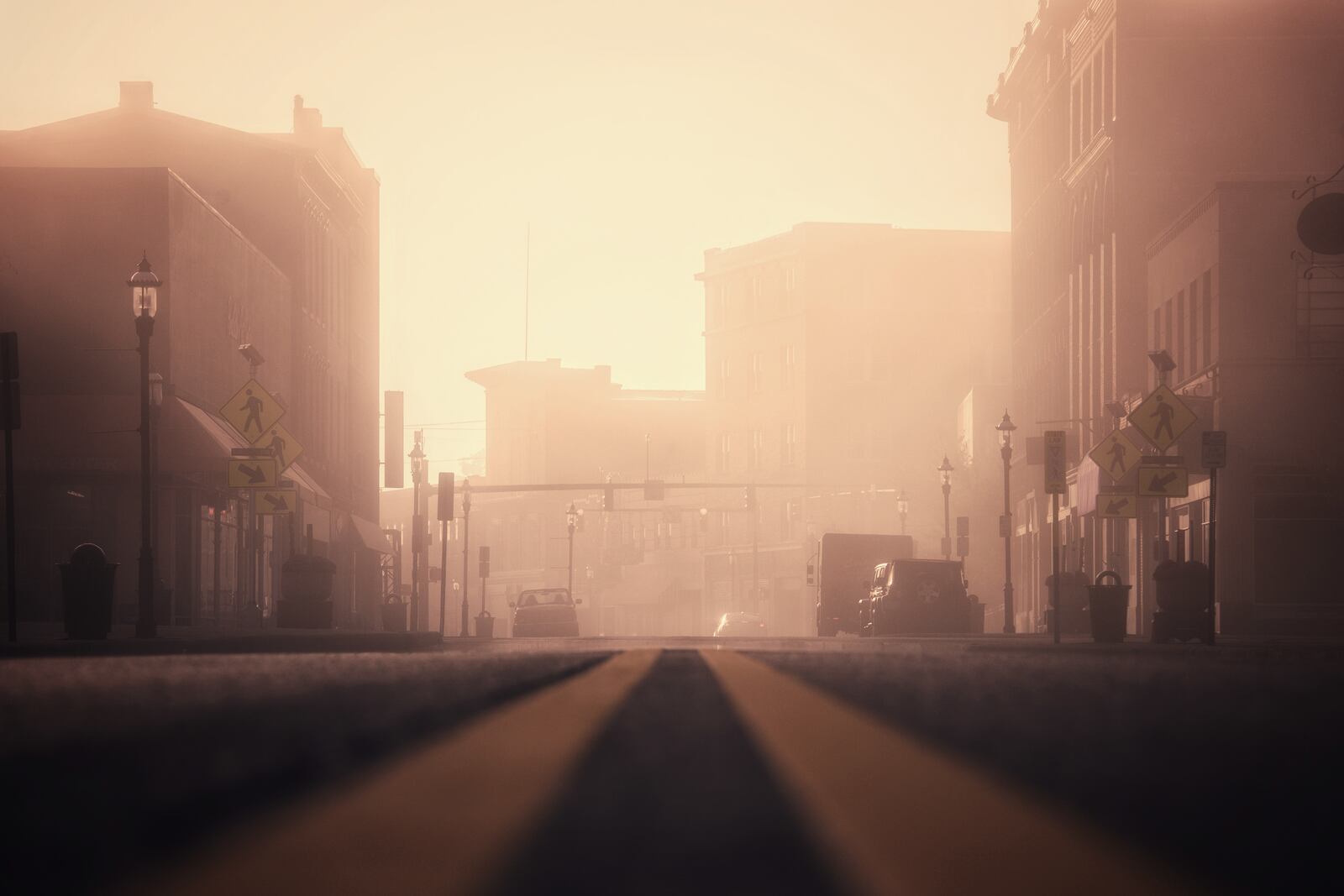 Fog is illuminated by the morning sun Thursday morning, Oct. 18 on Central Avenue in downtown Middletown. NICK GRAHAM/STAFF