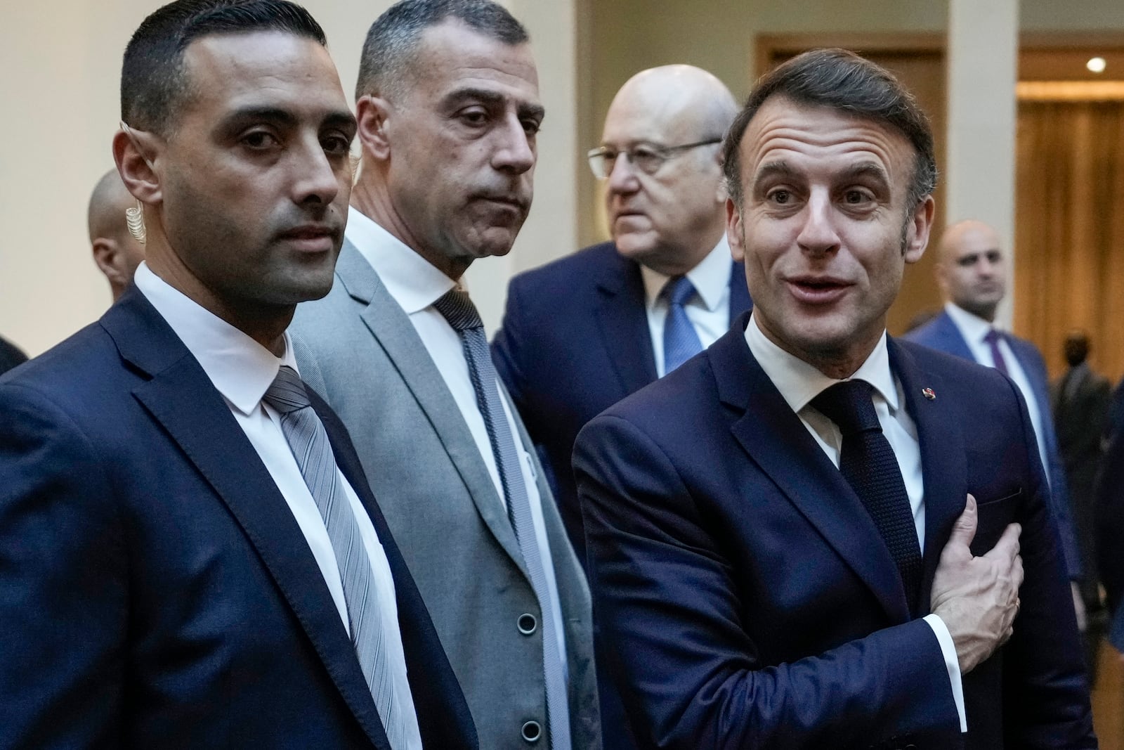 French President Emmanuel Macron, right, speaks with journalists after his meeting with Lebanese caretaker Prime Minister Najib Mikati upon his arrival at Beirut's Rafic Hariri International Airport in Beirut, Lebanon, Friday, Jan. 17, 2025. (AP Photo/Hassan Ammar)