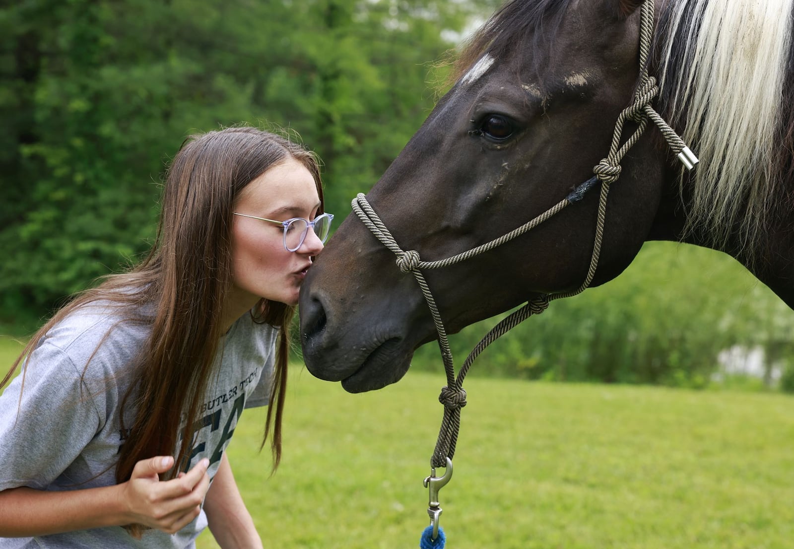 Makayla Krazl, 17, kisses her Tennessee walking horse, Milo, at her house Tuesday, July 18, 2023 in Wayne Township. Krazl will be showing her horse and goats at the Butler County Fair. NICK GRAHAM/STAFF