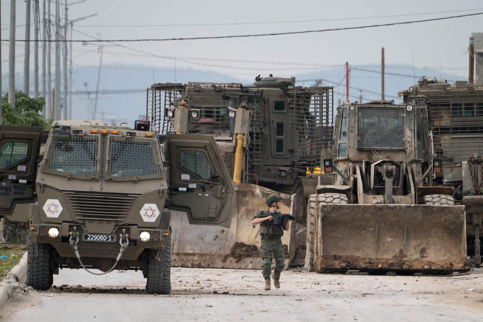 Israeli army vehicles are seen during a military operation in the West Bank city of Jenin, Wednesday, Jan. 22, 2025. (AP Photo/Majdi Mohammed)