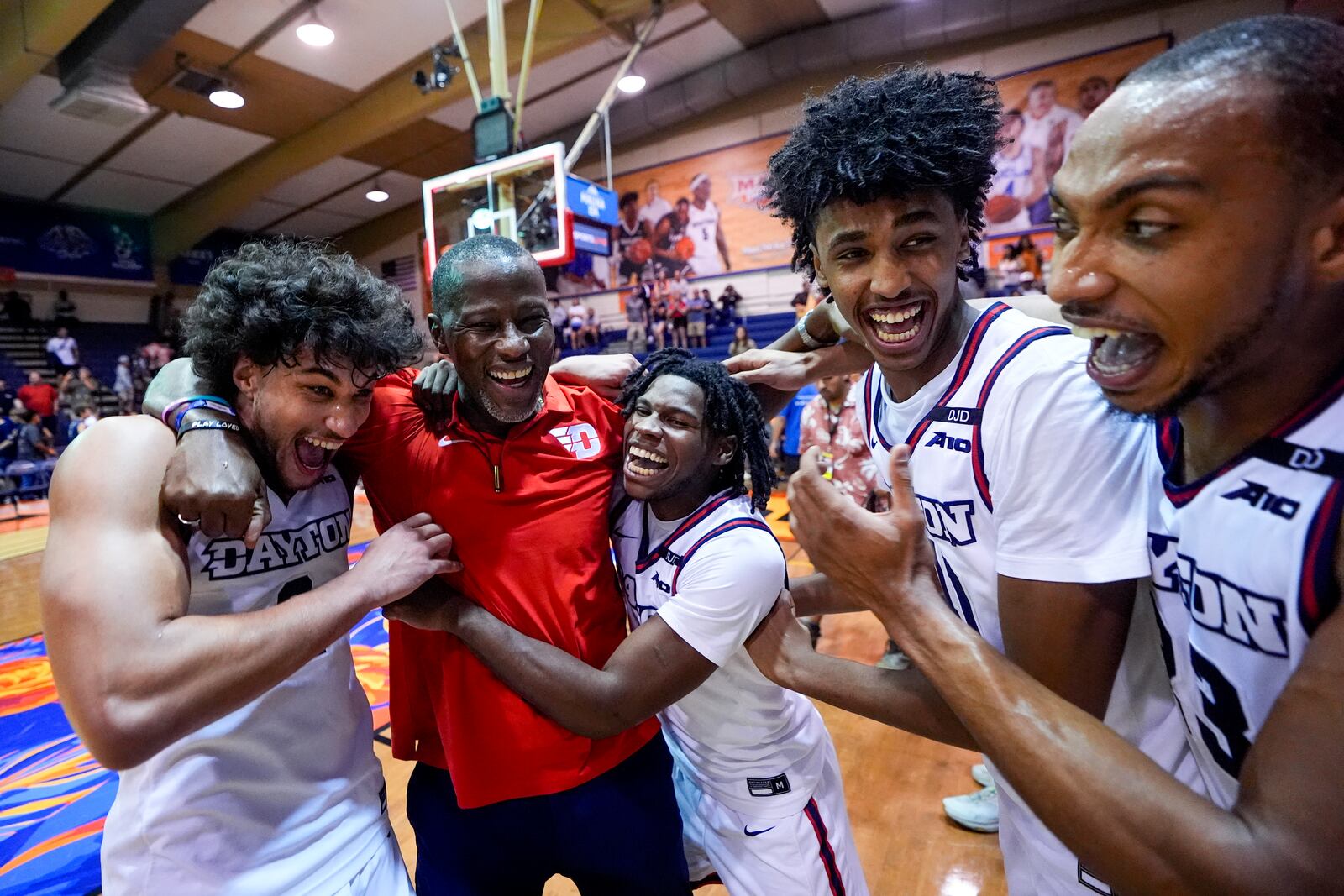 From left, Dayton forward Nate Santos, Dayton head coach Anthony Grant, guard Malachi Smith, guard Hamad Mousa and forward Zed Key celebrate an 85-67 win over UConn in an NCAA college basketball game at the Maui Invitational Wednesday, Nov. 27, 2024, in Lahaina, Hawaii. (AP Photo/Lindsey Wasson)