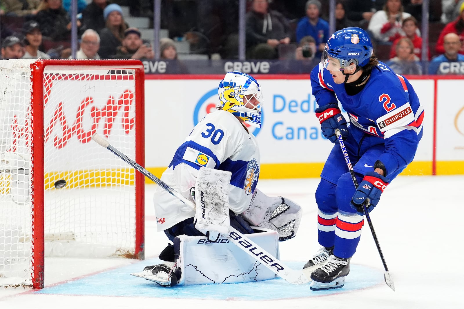 United States’ forward Teddy Stiga (2) scores the game-winning goal on Finland goaltender Petteri Rimpinen (30) to end overtime the IIHF World Junior Hockey Championship gold medal game in Ottawa, Ontario, Sunday, Jan. 5, 2025. (Sean Kilpatrick/The Canadian Press via AP)