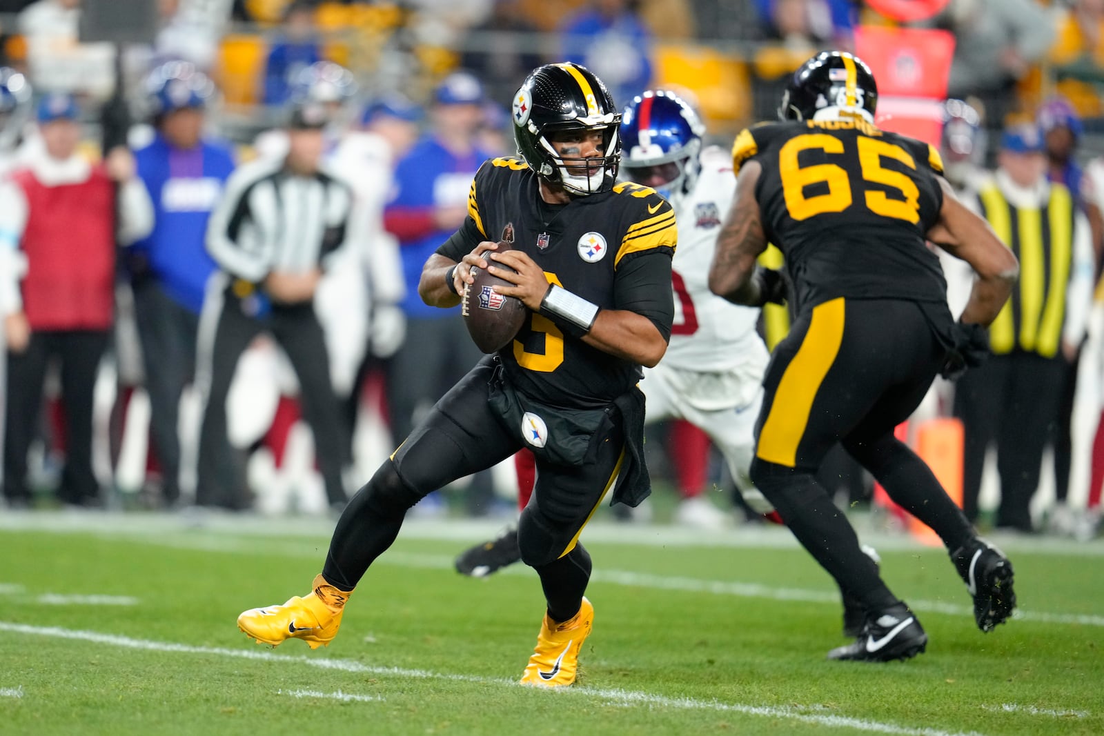 Pittsburgh Steelers quarterback Russell Wilson (3) rolls out during the first half of an NFL football game against the New York Giants, Monday, Oct. 28, 2024, in Pittsburgh. (AP Photo/Gene J. Puskar)