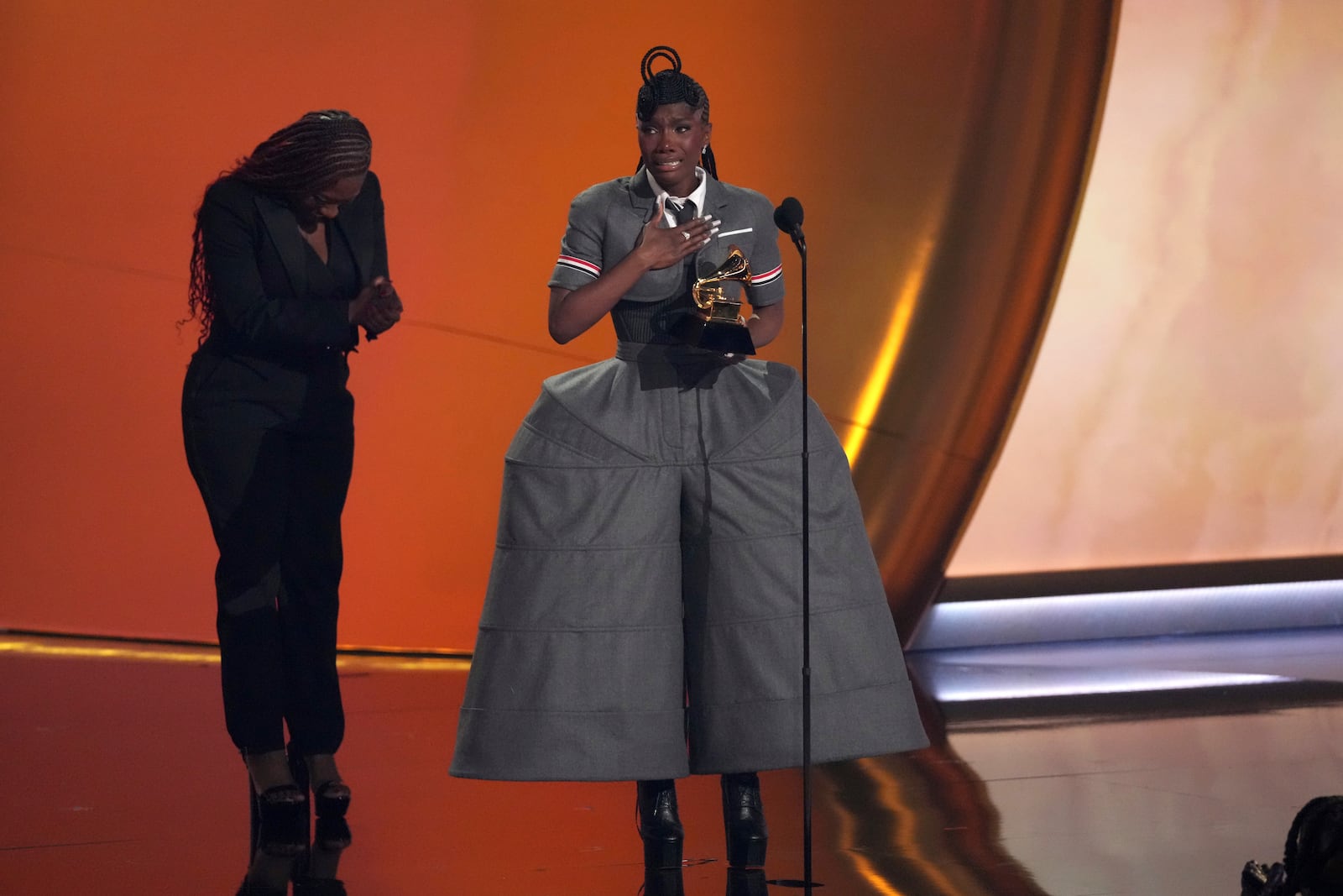 Doechii, center, accepts the award for best rap album for "Alligator Bites Never Heal" during the 67th annual Grammy Awards on Sunday, Feb. 2, 2025, in Los Angeles. Celesia Moore looks on from left(AP Photo/Chris Pizzello)