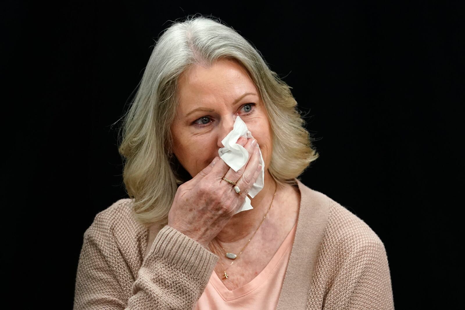 Karen Price sister of Ted Price reacts as a letter is read from Ted Price's daughter Brittany after the execution of Aaron Brian Gunches at the Arizona State Prison Wednesday, March 19, 2025 in Florence, Ariz. (AP Photo/Darryl Webb)