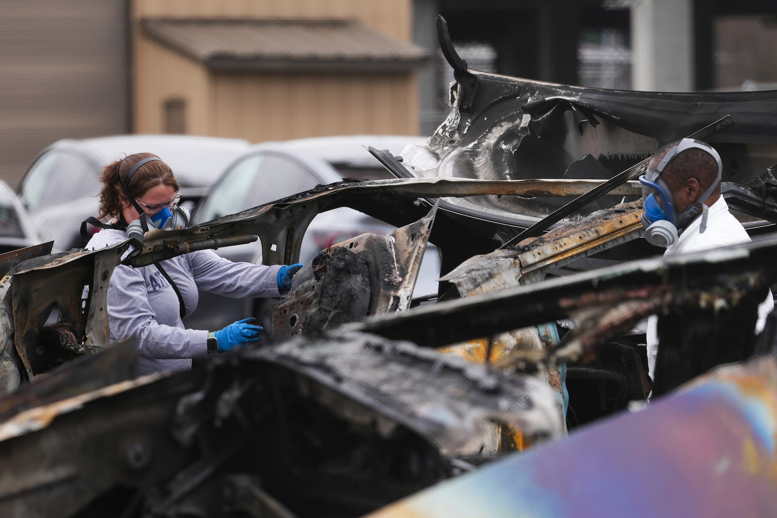 ATF investigators take apart and document a burned Tesla Cybertruck at a Tesla lot in Seattle, Monday, March 10, 2025. (AP Photo/Lindsey Wasson)