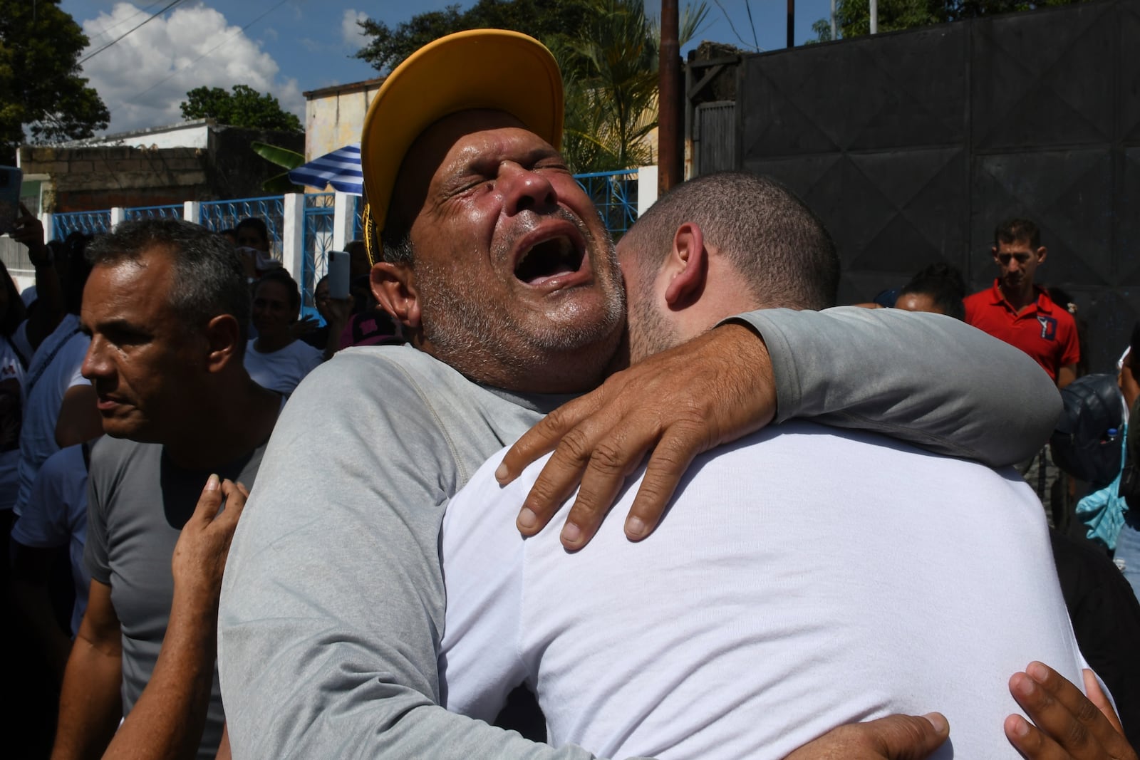 Cesar Salmeron, left, embraces his son Antony Salmeron upon his release from prison in Tocuyito, Venezuela, Saturday, Nov. 16, 2024. Antony Salmeron was detained during a government crackdown following anti-government protests against the results of the presidential election. (AP Photo/Jacinto Oliveros)