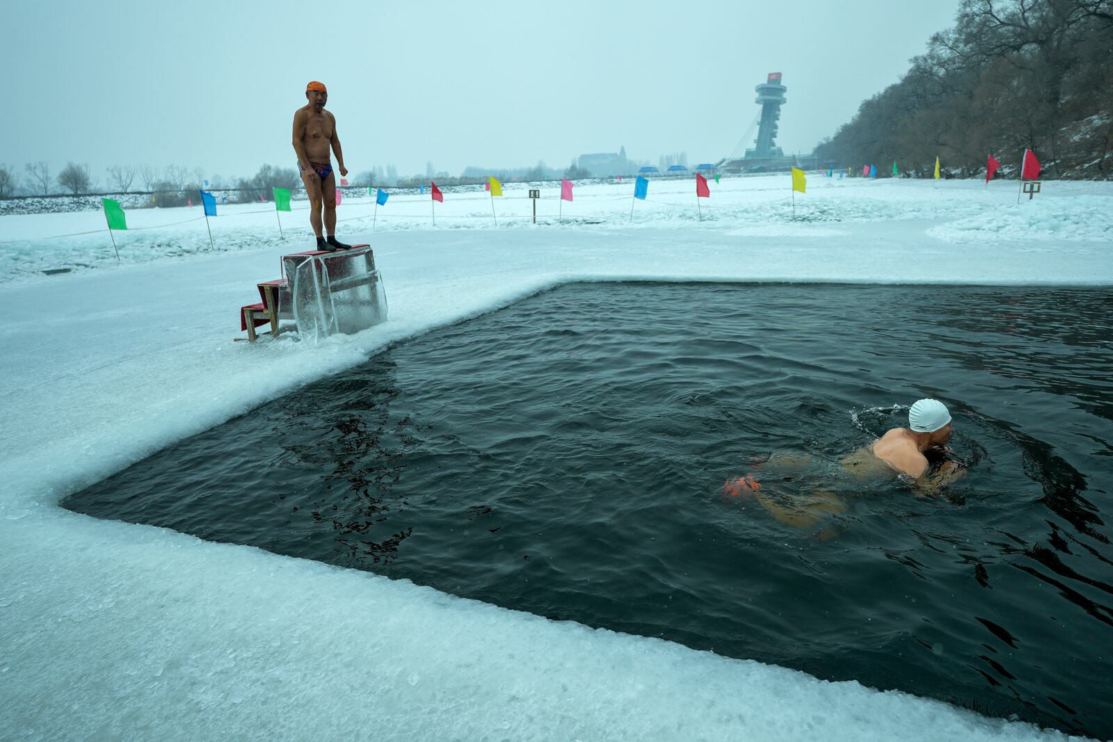 Residents swim in a pool carved from ice on the frozen Songhua river in Harbin in northeastern China's Heilongjiang province, Tuesday, Jan. 7, 2025. (AP Photo/Andy Wong)