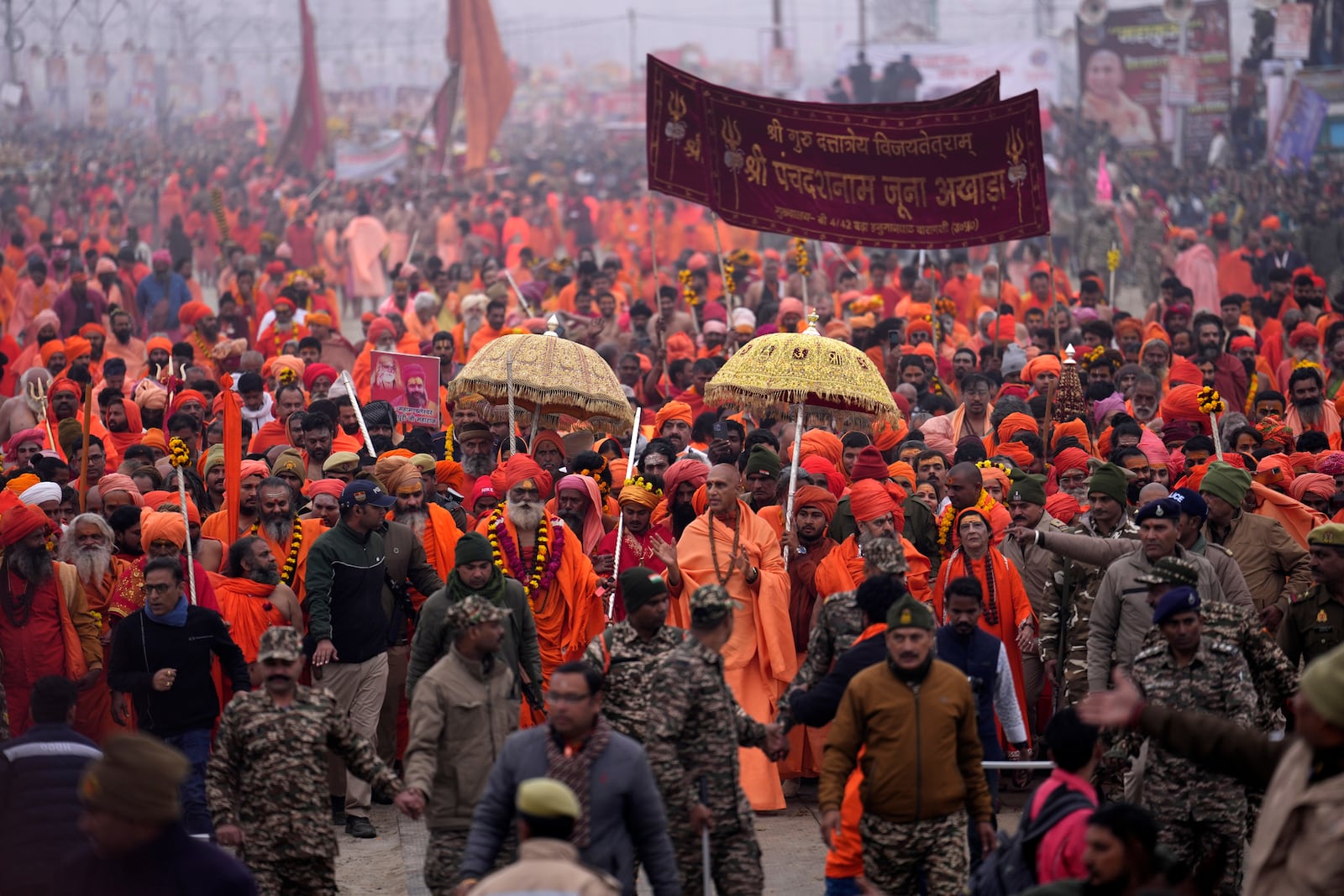 Hindu ascetics arrive for ritualistic dip at Sangam, the confluence of the Rivers Ganges, Yamuna and mythical Saraswati on one of the most auspicious day Makar Sankranti, for the Maha Kumbh festival in Prayagraj, India, Tuesday, Jan. 14, 2025. (AP Photo/Rajesh Kumar Singh)