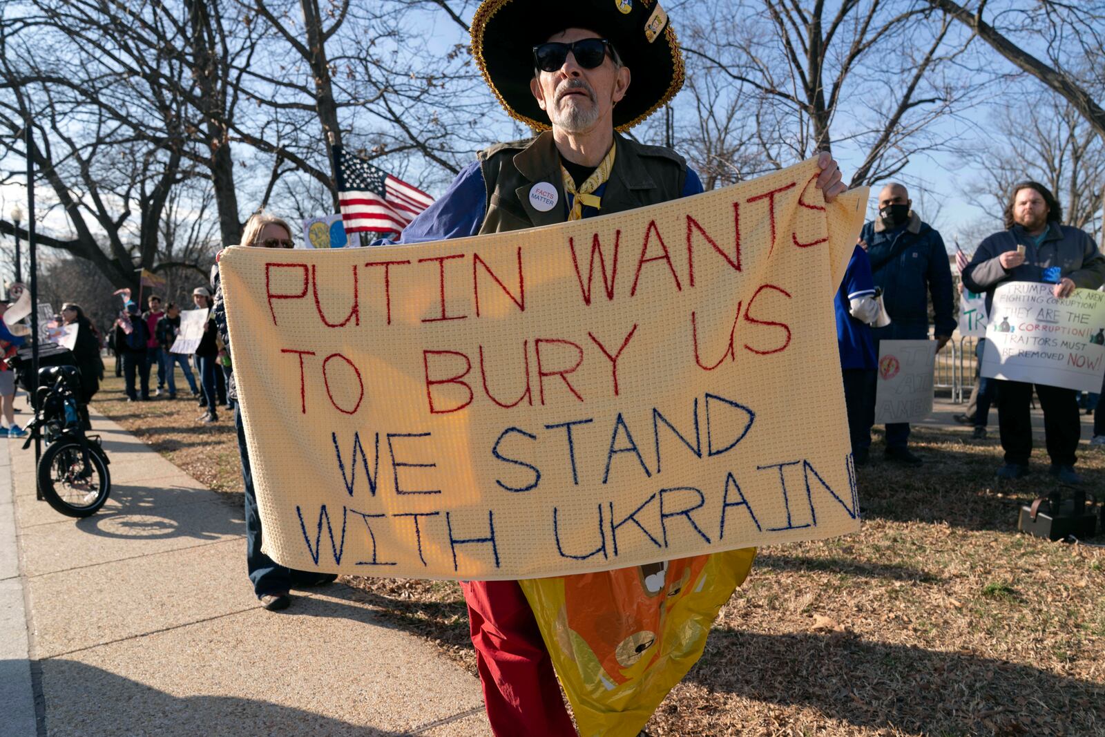 Demonstrators protest near the U.S. Capitol ahead of President Donald Trump address to a joint session of Congress in Washington, Tuesday, March 4, 2025. (AP Photo/Jose Luis Magana)