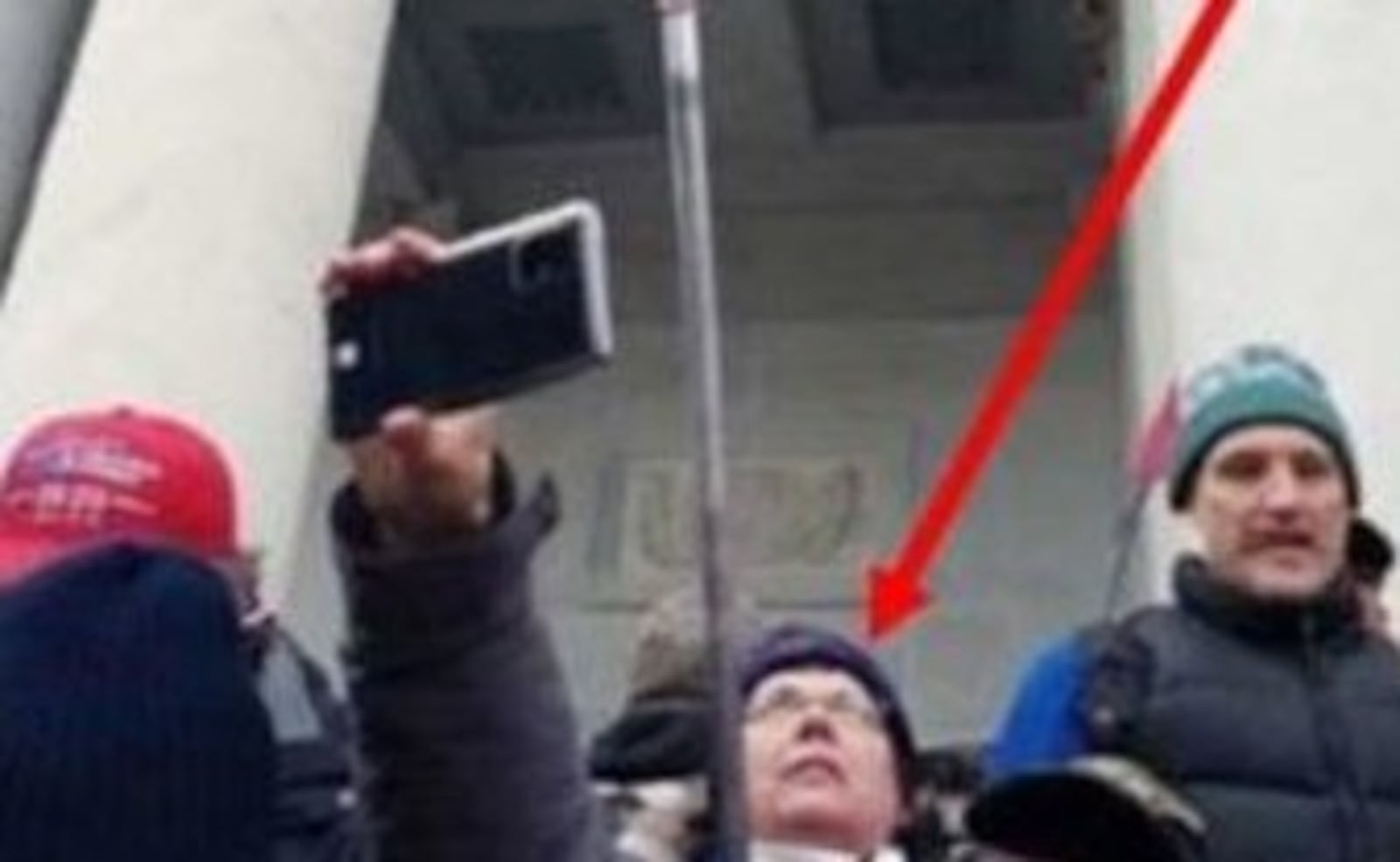 Jan. 6 U.S. Capitol riot: Therese Borgerding of Piqua is shown on the Capitol steps holding a "Q" sign in images filed in U.S. District Court for the District of Columbia.