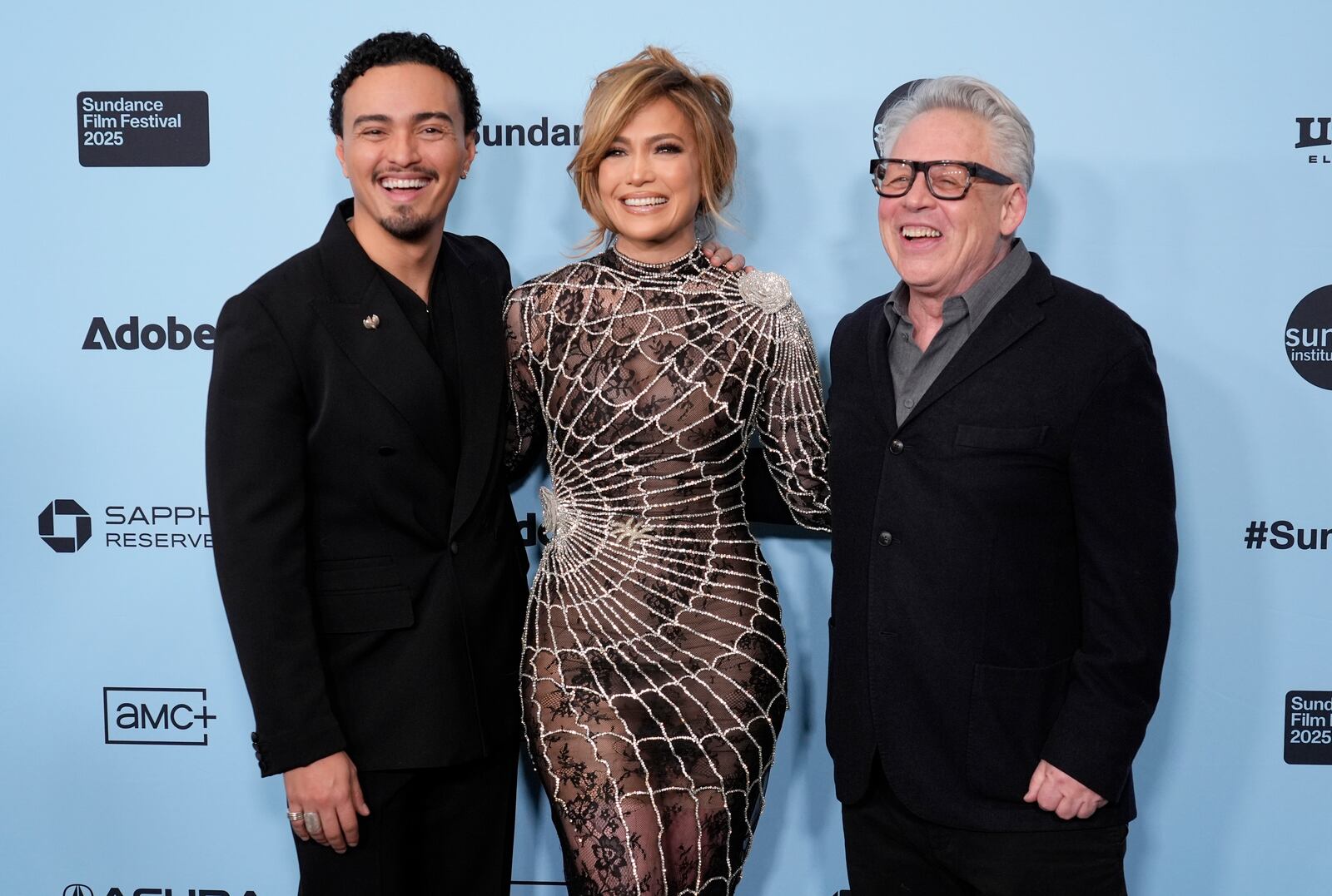 Bill Condon, right, writer/director of "Kiss of the Spider Woman," poses with cast members Tonatiuh, left, and Jennifer Lopez at the premiere of the film during the Sundance Film Festival on Sunday, Jan. 26, 2025, in Park City, Utah. (AP Photo/Chris Pizzello)