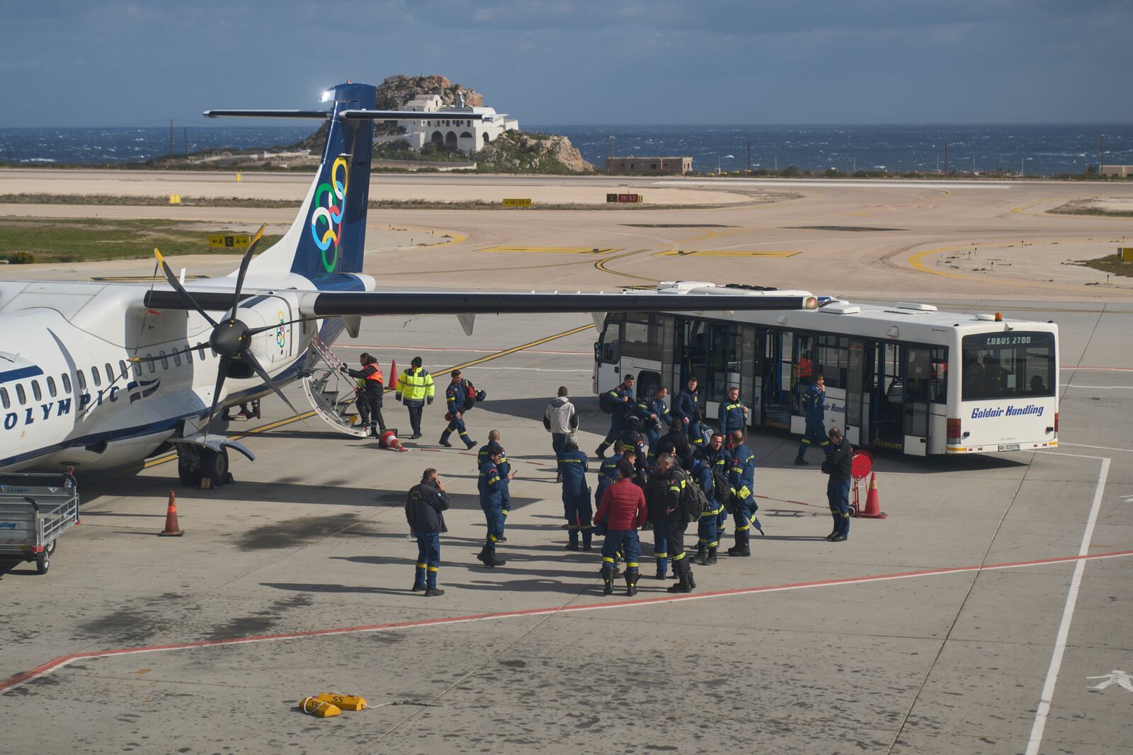 Fire service rescuers arrive at the airport of the earthquake-hit island of Santorini, Greece, on Wednesday, Feb. 5, 2025. (AP Photo/Petros Giannakouris)