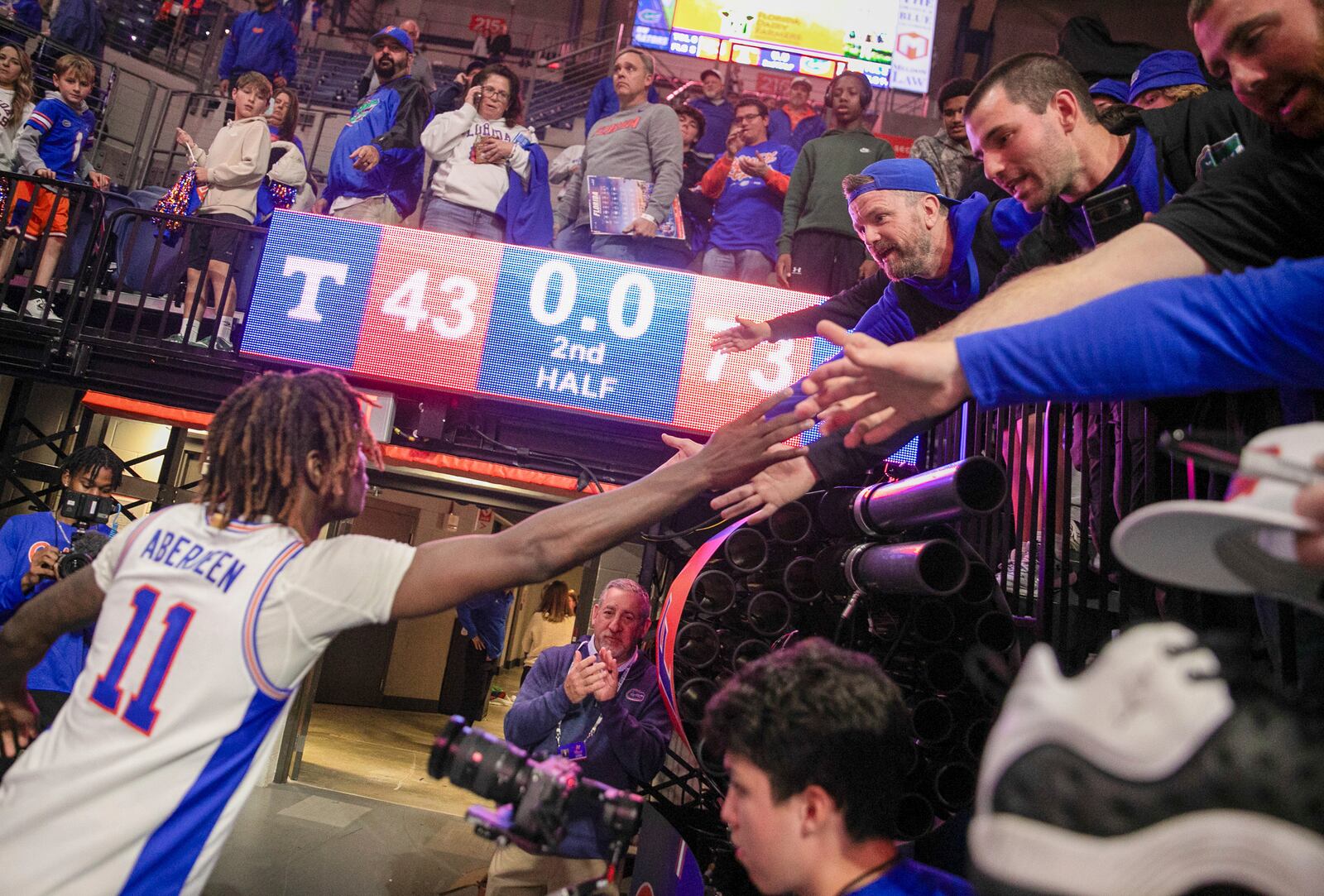 Florida guard Denzel Aberdeen (11) celebrates with fan after defeating Tennessee 73-43 in an NCAA college basketball game Tuesday, Jan. 7, 2025, in Gainesville, Fla. (AP Photo/Alan Youngblood)