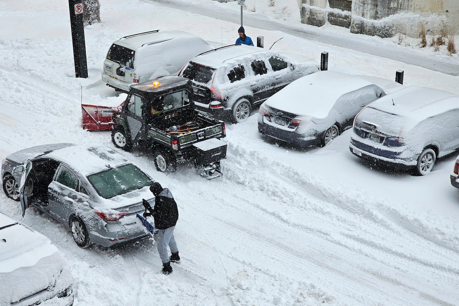 A snowplow helps free a stuck driver in Minneapolis on Wednesday, March 5, 2025, amid the heaviest snowfall of the season in the city. (AP Photo/Steve Karnowski)