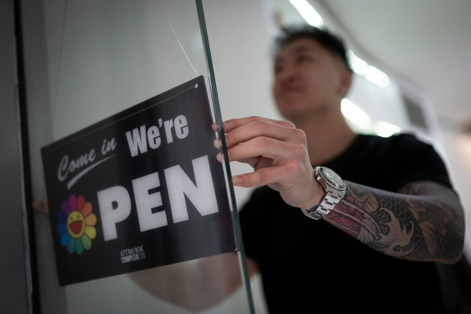 The doors are opened for the evening rush 12 Pell, a local barbershop in Manhattan's Chinatown, Thursday, Jan. 25, 2024, in New York. (AP Photo/John Minchillo)