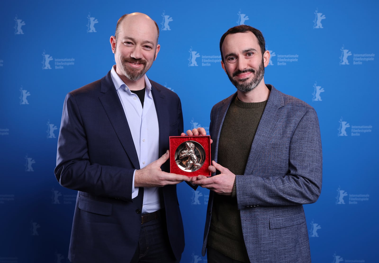 US director Brandon Kramer, right, and US director Lance Kramer pose with the Berlinale Documentary Award during the winner's photocall at the International Film Festival, Berlinale, in Berlin, Saturday, Feb. 22, 2025. (Ronny Hartmann/Pool via AP)