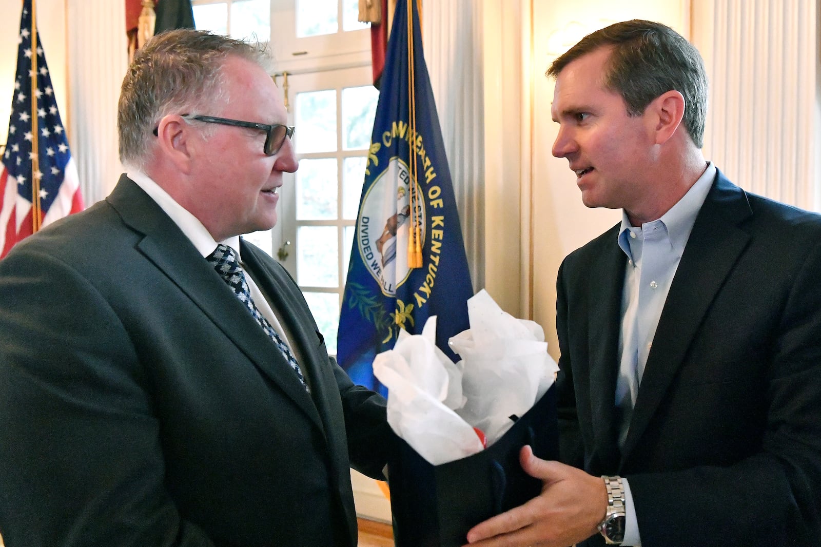 Colin Parkin, left, President of e-Storage, speaks with Shelby County Judge Executive Dan Ison following the announcement of a $712 million project in Shelbyville, Ky., creating 1,572 skilled, high-tech jobs at the Governor's Mansion in Frankfort, Ky., Friday, Nov. 15, 2024. (AP Photo/Timothy D. Easley)