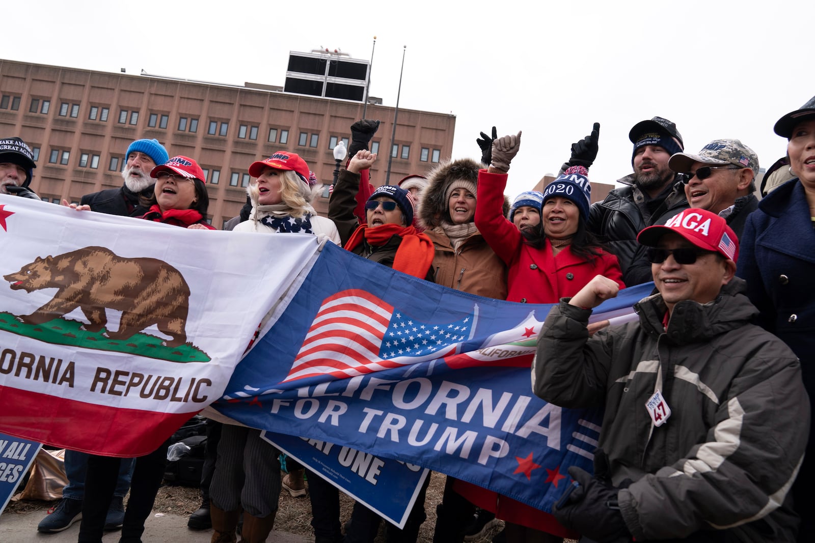 Supporters of President Donald stand with their flags in support of people convicted for their part in the Jan. 6 riot at the U.S. Capitol at the DC Central Detention Facility in Washington, Tuesday, Jan. 21, 2025. (AP Photo/Jose Luis Magana)