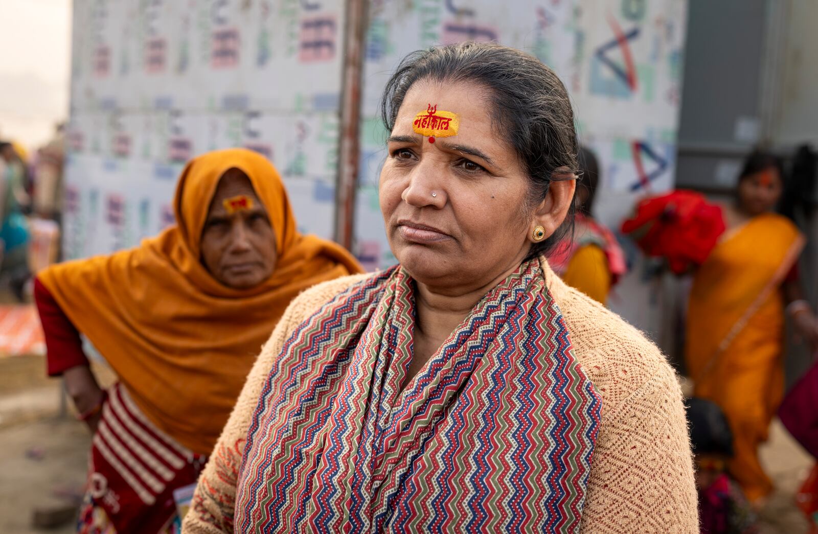 Sushila Chauhan wears a sacred mark on her forehead reading 'Mahakal' at the confluence of the Ganges, the Yamuna, and the Saraswati rivers during the 45-day-long Maha Kumbh festival in Prayagraj, India, Tuesday, Jan. 14, 2025. (AP Photo/Ashwini Bhatia)