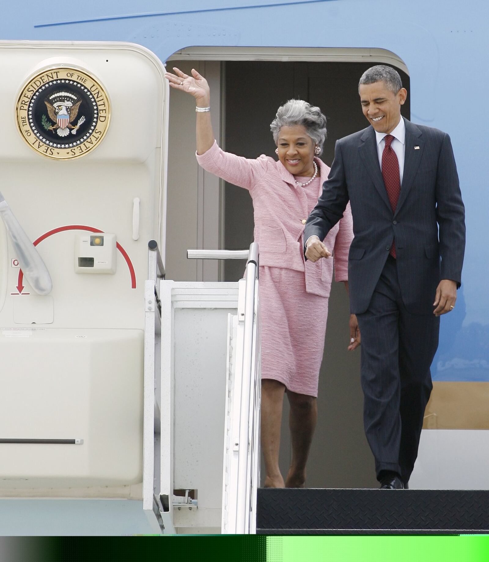 President Barack Obama, right, and Rep. Joyce Beatty, D-Ohio, react to a crowd of supporters after arriving at Rickenbacker International Airport Sunday, May 5, 2013 in Columbus, Ohio. The President is in town to give the commencement address at The Ohio State University. (AP Photo/Mike Munden)