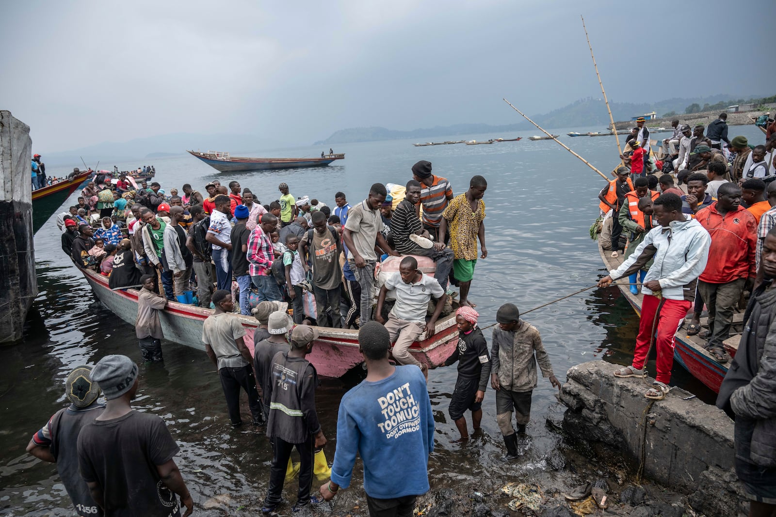 People fleeing M-23 rebel advances arrive by boat in Goma, Democratic Republic of the Congo, Wednesday, Jan. 22, 2025. (AP Photo/Moses Sawasawa)