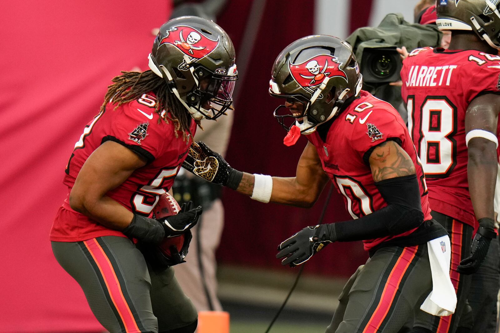 Tampa Bay Buccaneers linebacker J.J. Russell celebrates after scoring on a blocked punt with wide receiver Trey Palmer during the second half of an NFL football game against the Carolina Panthers Sunday, Dec. 29, 2024, in Tampa, Fla. (AP Photo/Chris O'Meara)