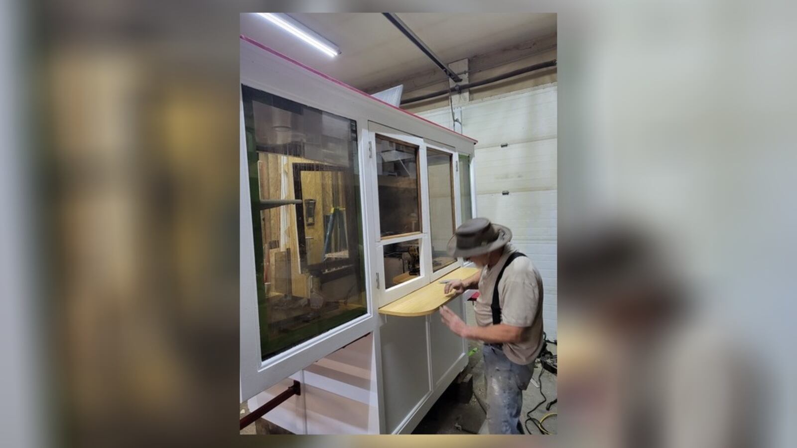 Dennis Moore, of Miamisburg, works to refurbish the Hamburger Wagon, which sells its burger-pickle-onion combo at Market Square in Miamisburg. Hamburger Wagon owner Jack Sperry said the renovations are meant to extend the wagon's longevity and make it easier to clean. CONTRIBUTED