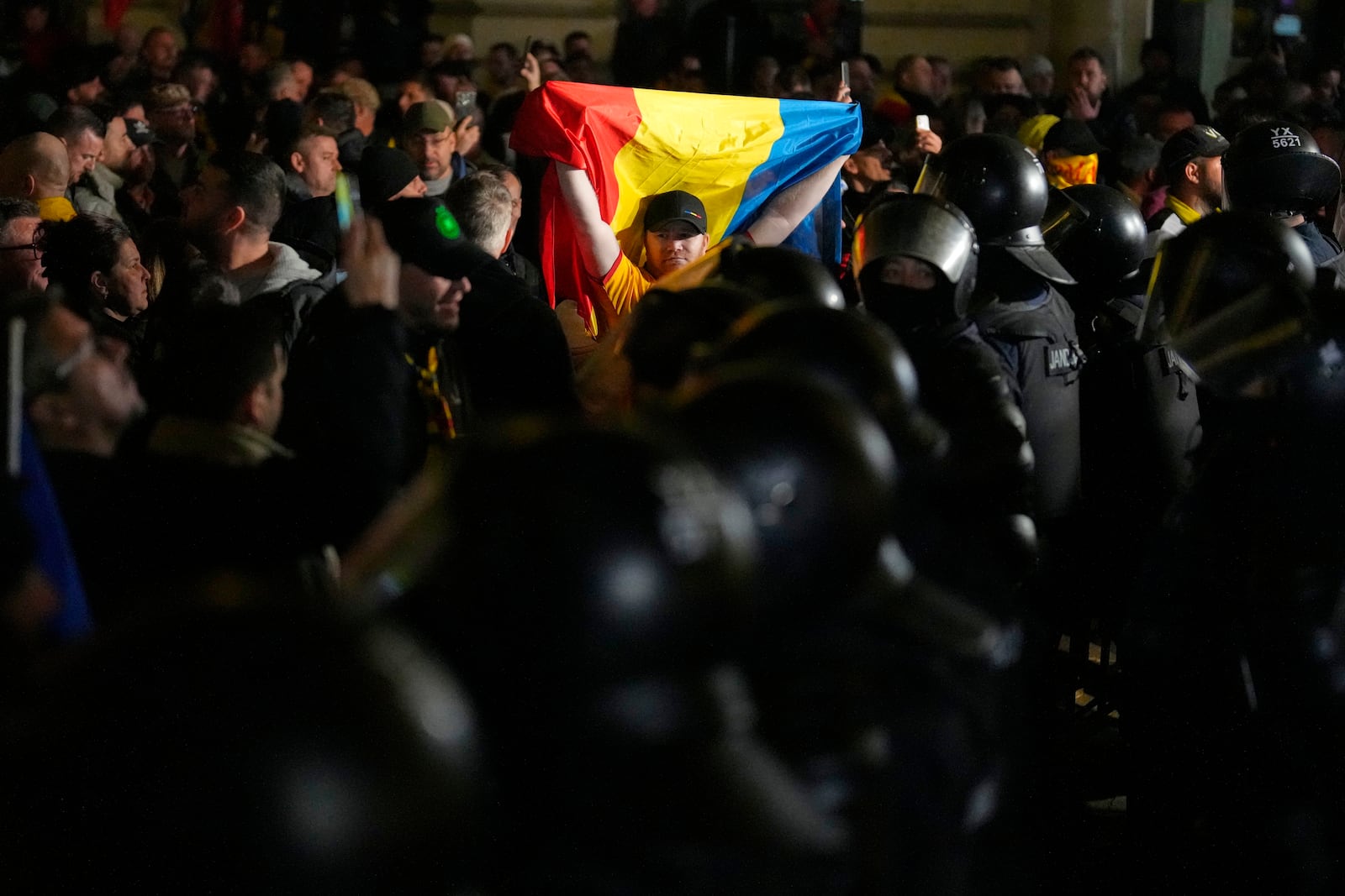 A supporter of Calin Georgescu reacts during a protest after Romania's electoral body rejected his candidacy in the presidential election rerun in Bucharest, Romania, Sunday, March 9, 2025. (AP Photo/Vadim Ghirda)