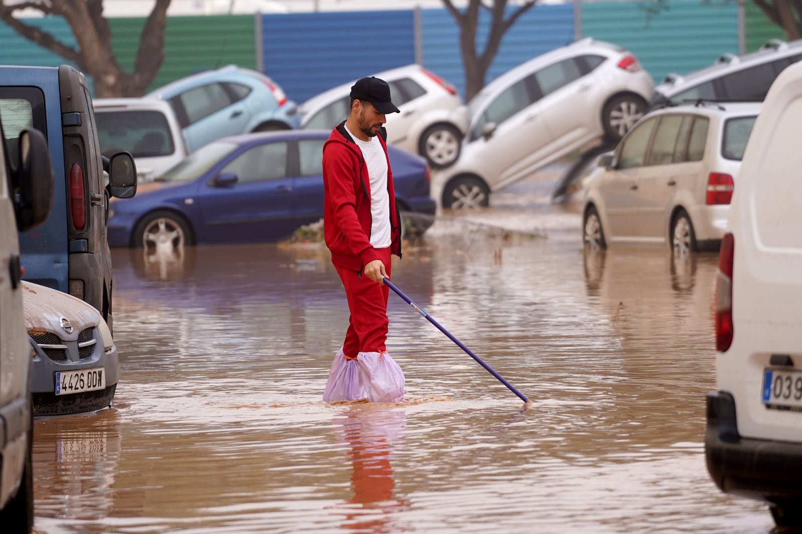 A man walks through flooded streets in Valencia, Spain, Wednesday, Oct. 30, 2024. (AP Photo/Alberto Saiz)