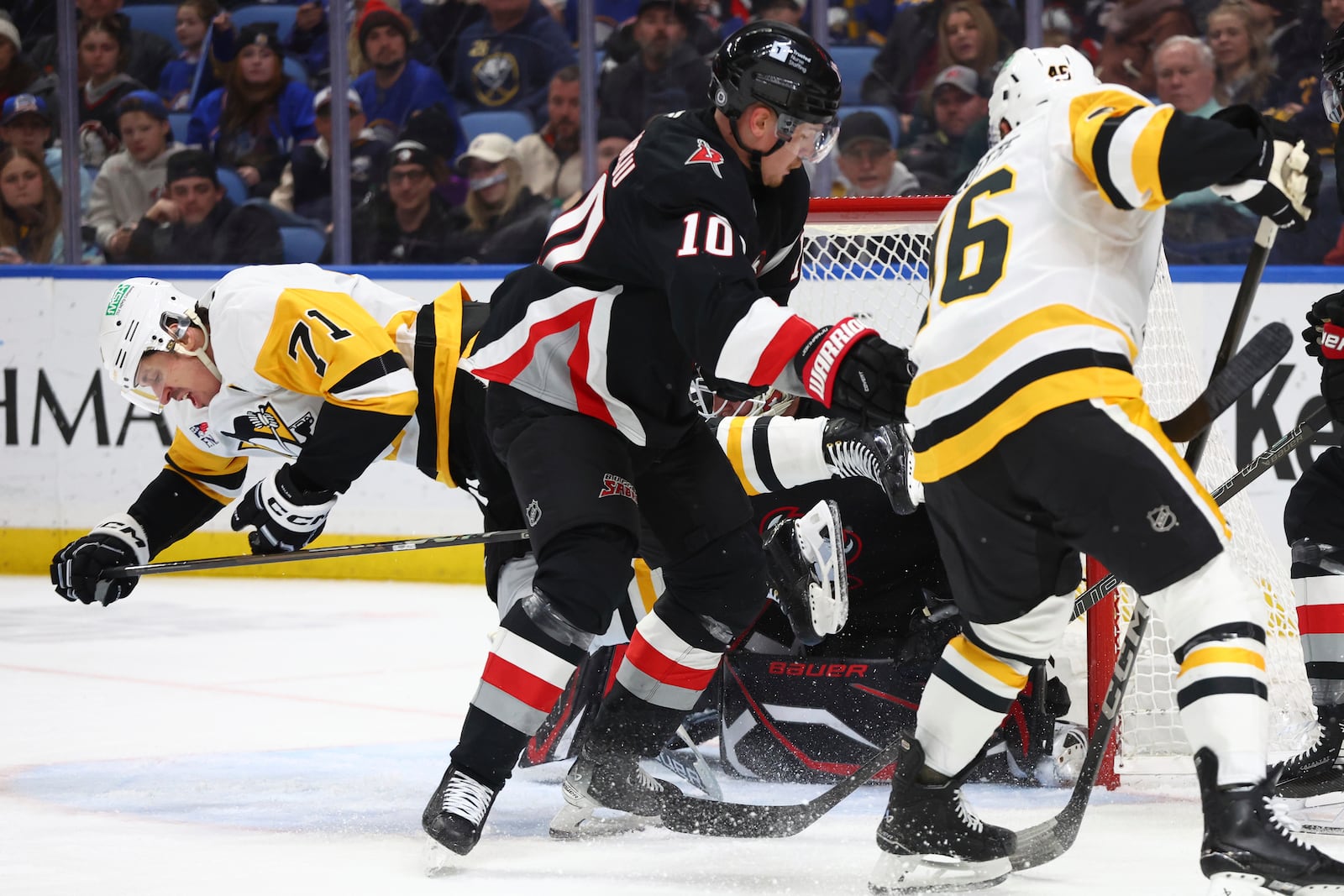 Pittsburgh Penguins center Evgeni Malkin (71) is brought down by Buffalo Sabres defenseman Henri Jokiharju (10)during the second period of an NHL hockey game Friday, Jan. 17, 2025, in Buffalo, N.Y. (AP Photo/Jeffrey T. Barnes)