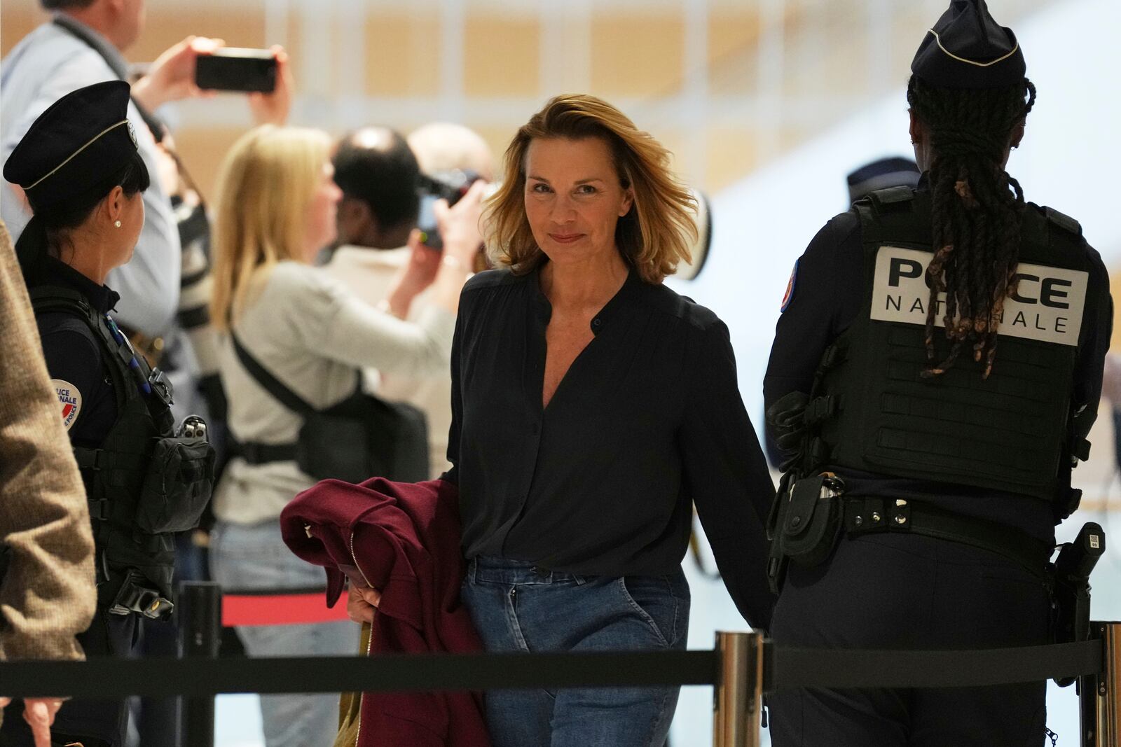 A plaintiff arrives as actor Gerard Depardieu face his trial for the alleged sexual assaults of two women on a film set in 2021, with his lawyer Jeremie Assous ,Tuesday, March 25, 2025 in Paris. (AP Photo/Aurelien Morissard)