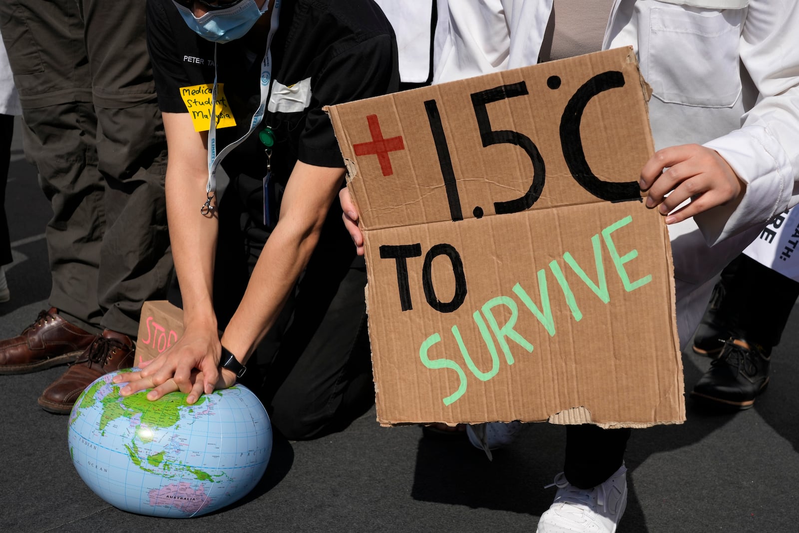 FILE - Demonstrators pretend to resuscitate the Earth while advocating for the 1.5 degree warming goal to survive at the COP27 U.N. Climate Summit, Nov. 16, 2022, in Sharm el-Sheikh, Egypt. (AP Photo/Peter Dejong, File)