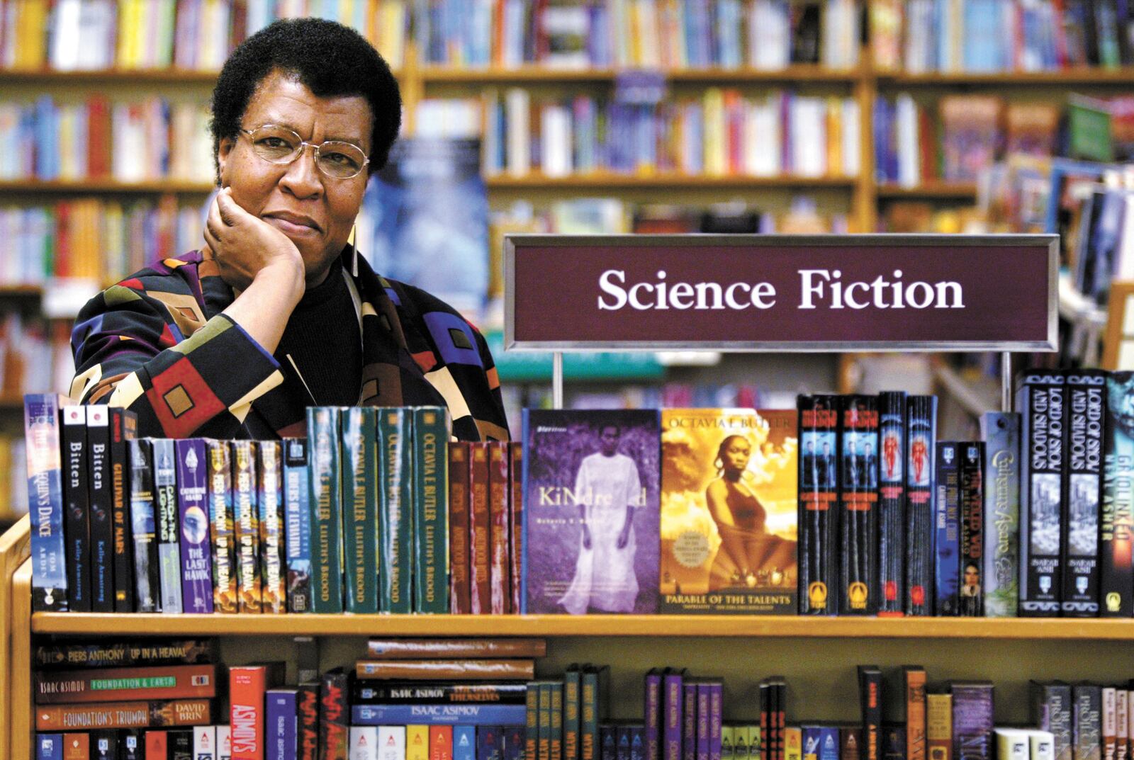 FILE - Science Fiction writer Octavia Butler poses for a photograph near some of her novels at University Book Store in Seattle, Wash., on Feb. 4, 2004. (Joshua Trujillo/seattlepi.com via AP, File)