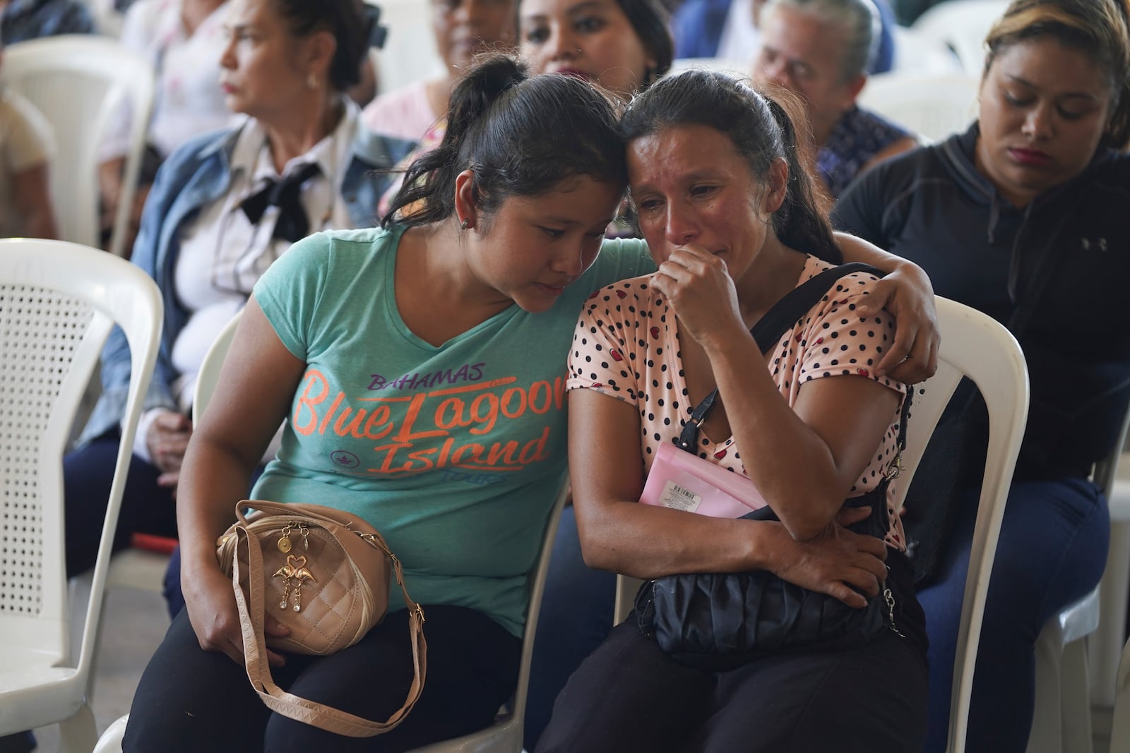 Mourners attend a funeral service for victims of a bus crash, in Santo Domingo Los Ocotes, Guatemala, Tuesday, Feb. 11, 2025. Dozens of passengers died after their bus plunged into a gorge and landed under a bridge on Feb. 10 on the outskirts of Guatemalan capital. (AP Photo/Moises Castillo)