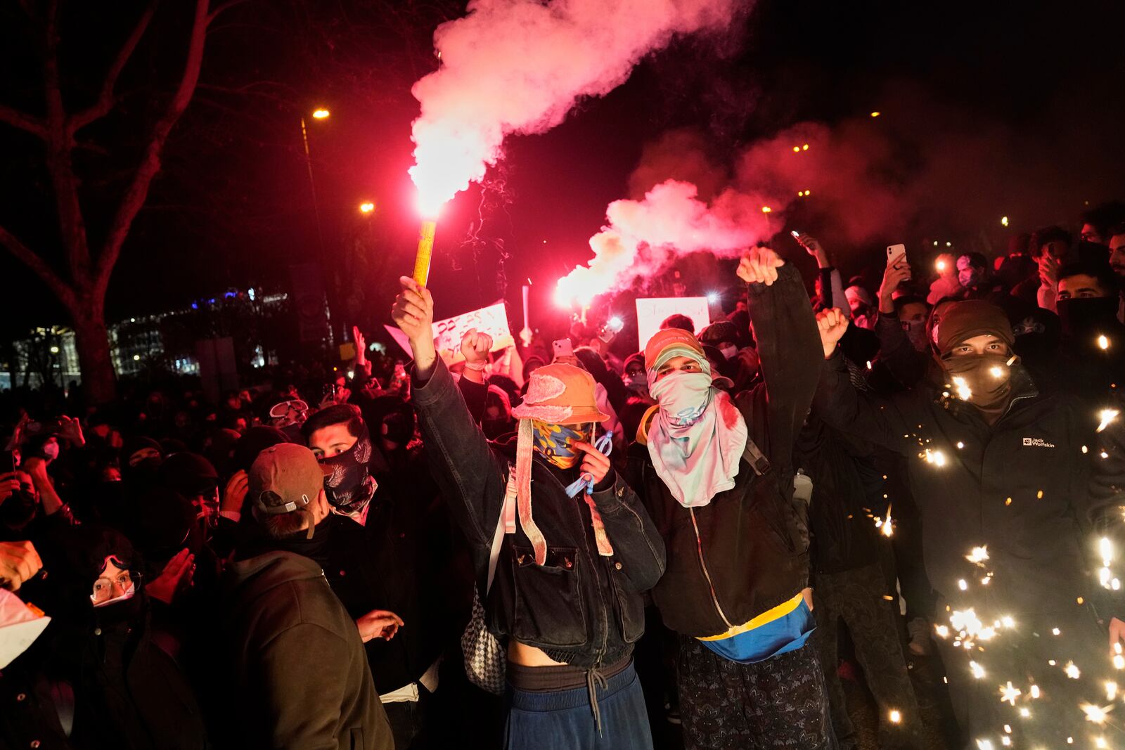 People light flares as they protest against the arrest of Istanbul's Mayor Ekrem Imamoglu, in Istanbul, Turkey, Friday, March 21, 2025. (AP Photo/Khalil Hamra)