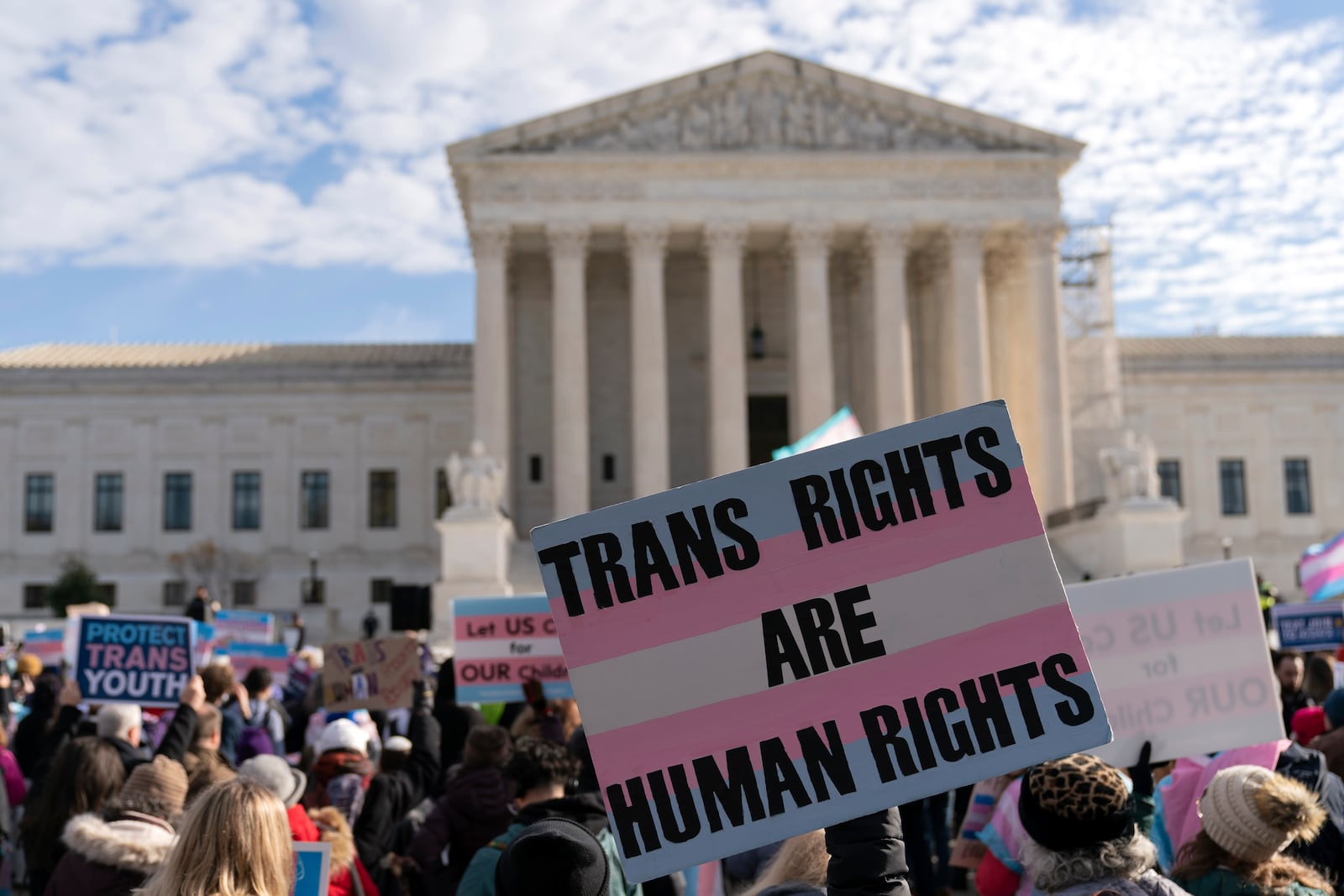 Transgenders rights supporters rally outside of the Supreme Court, Wednesday, Dec. 4, 2024, in Washington. (AP Photo/Jose Luis Magana)