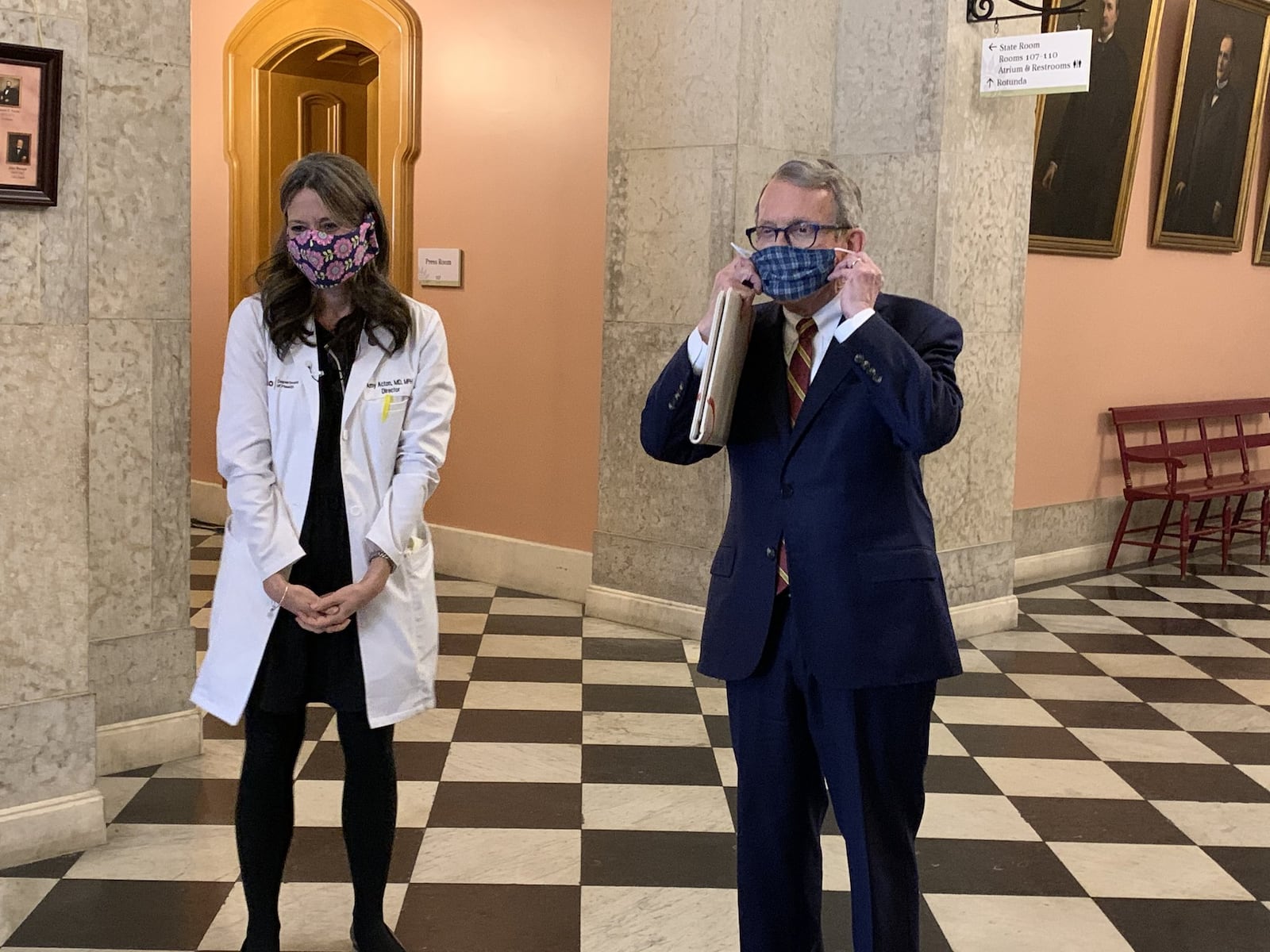 Ohio Gov. Mike DeWine and Ohio Health Department Director Dr. Amy Acton show off home-made protective masks at the Ohio Statehouse on Monday. Photo by Laura A Bischoff. Columbus Bureau