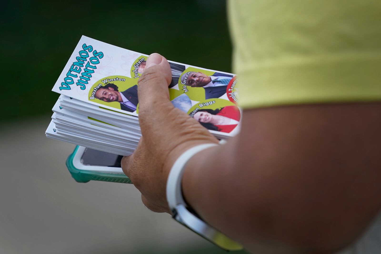 Elena Jimenez carries a voting guide during a voter engagement event for the Latino community in Greensboro, N.C., Saturday, Sept. 21, 2024. (AP Photo/Chuck Burton)