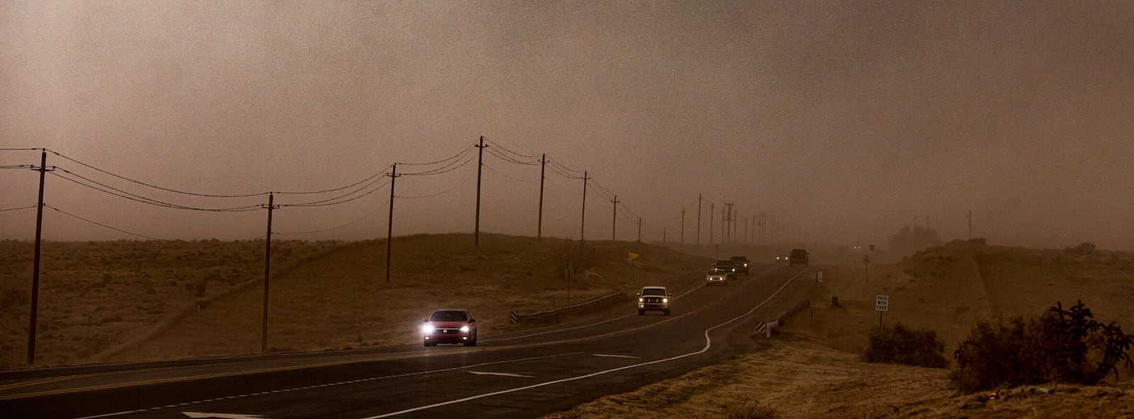 The wind and dust sweep over Highway 14 obscuring the road and the sky on Tuesday, March 18, 2025, in Santa Fe, N.M. (Gabriela Campos/Santa Fe New Mexican via AP)