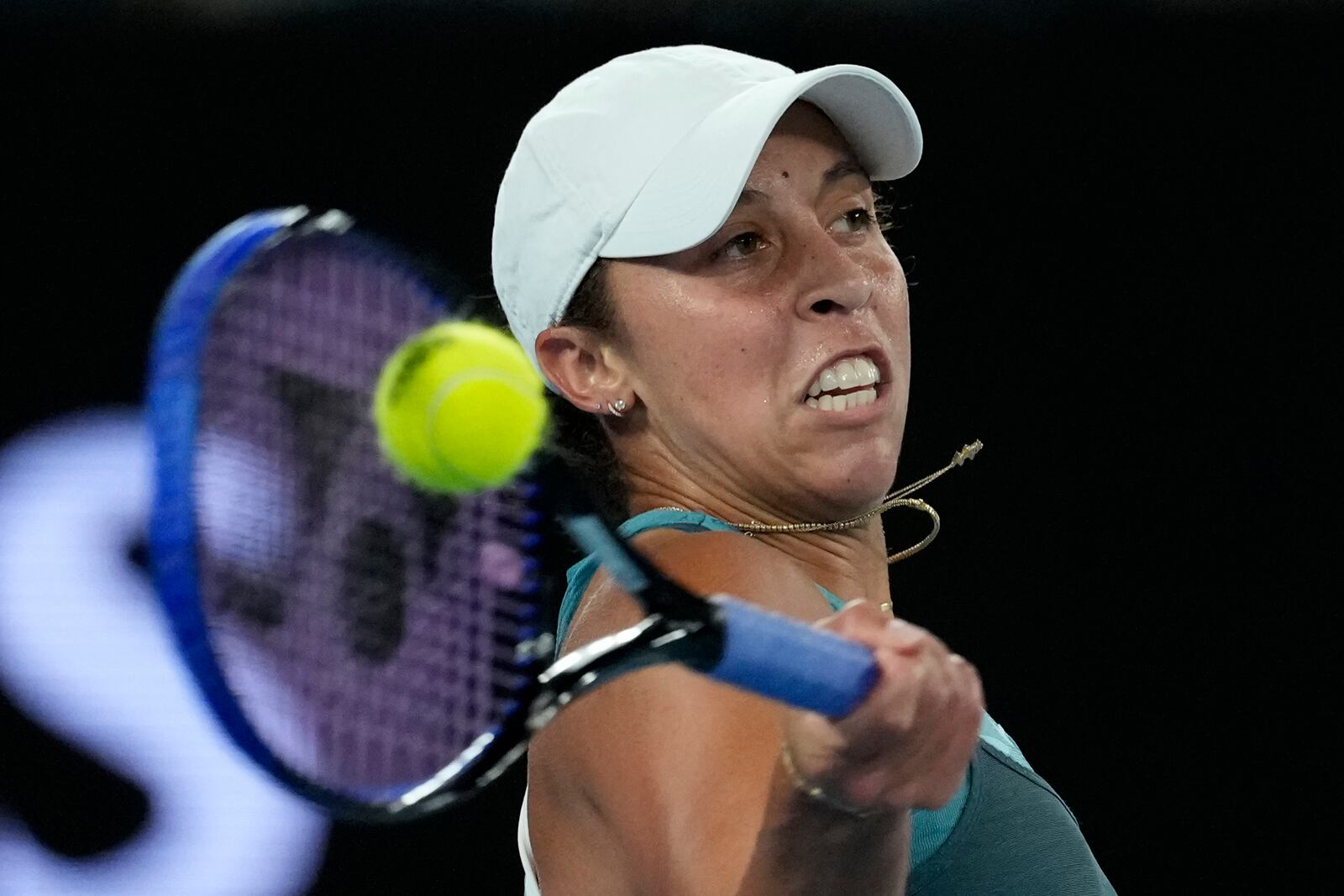 Madison Keys of the U.S. plays a forehand return to Iga Swiatek of Poland during their semifinal match at the Australian Open tennis championship in Melbourne, Australia, Thursday, Jan. 23, 2025. (AP Photo/Asanka Brendon Ratnayake)