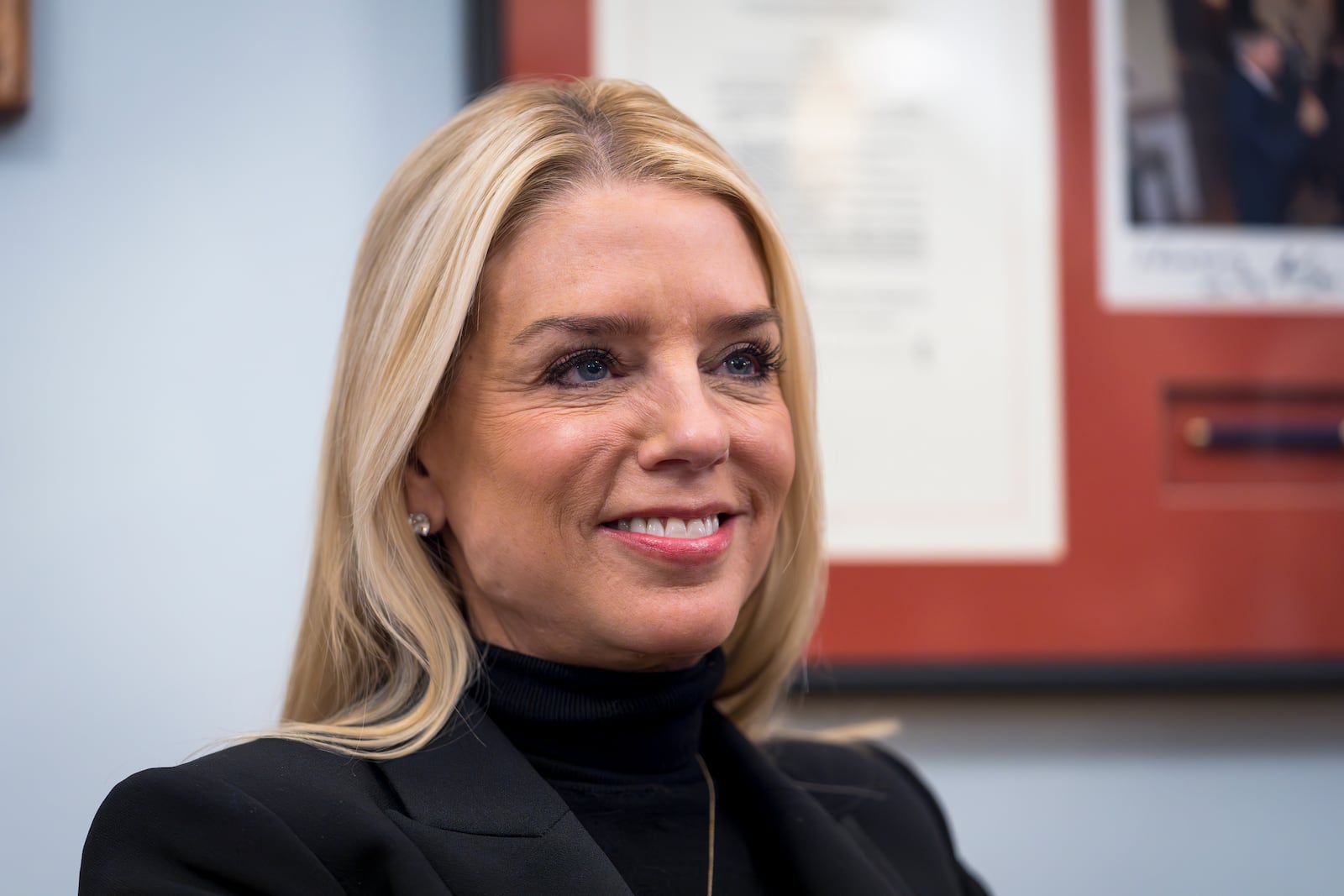 FILE - Pam Bondi, President-elect Donald Trump's nominee for Attorney General, listens during a meeting with Sen. Lindsey Graham, R-S.C., at the Capitol in Washington, Dec. 2, 2024. (AP Photo/J. Scott Applewhite, File)