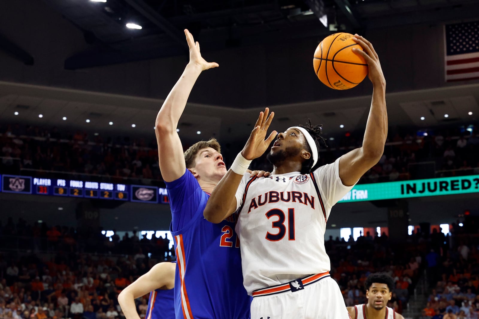 Auburn forward Chaney Johnson (31) looks to shoot over Florida forward Alex Condon, left, during the second half of an NCAA college basketball game, Saturday, Feb. 8, 2025, in Auburn, Ala. (AP Photo/Butch Dill)